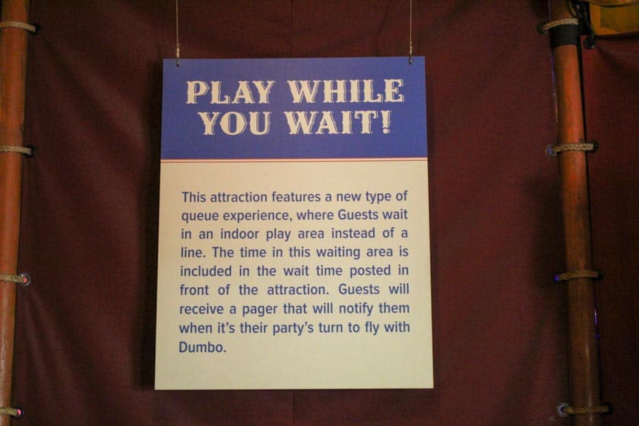 Sign that details the play while you wait area at Dumbo, the Flying Elephant. 