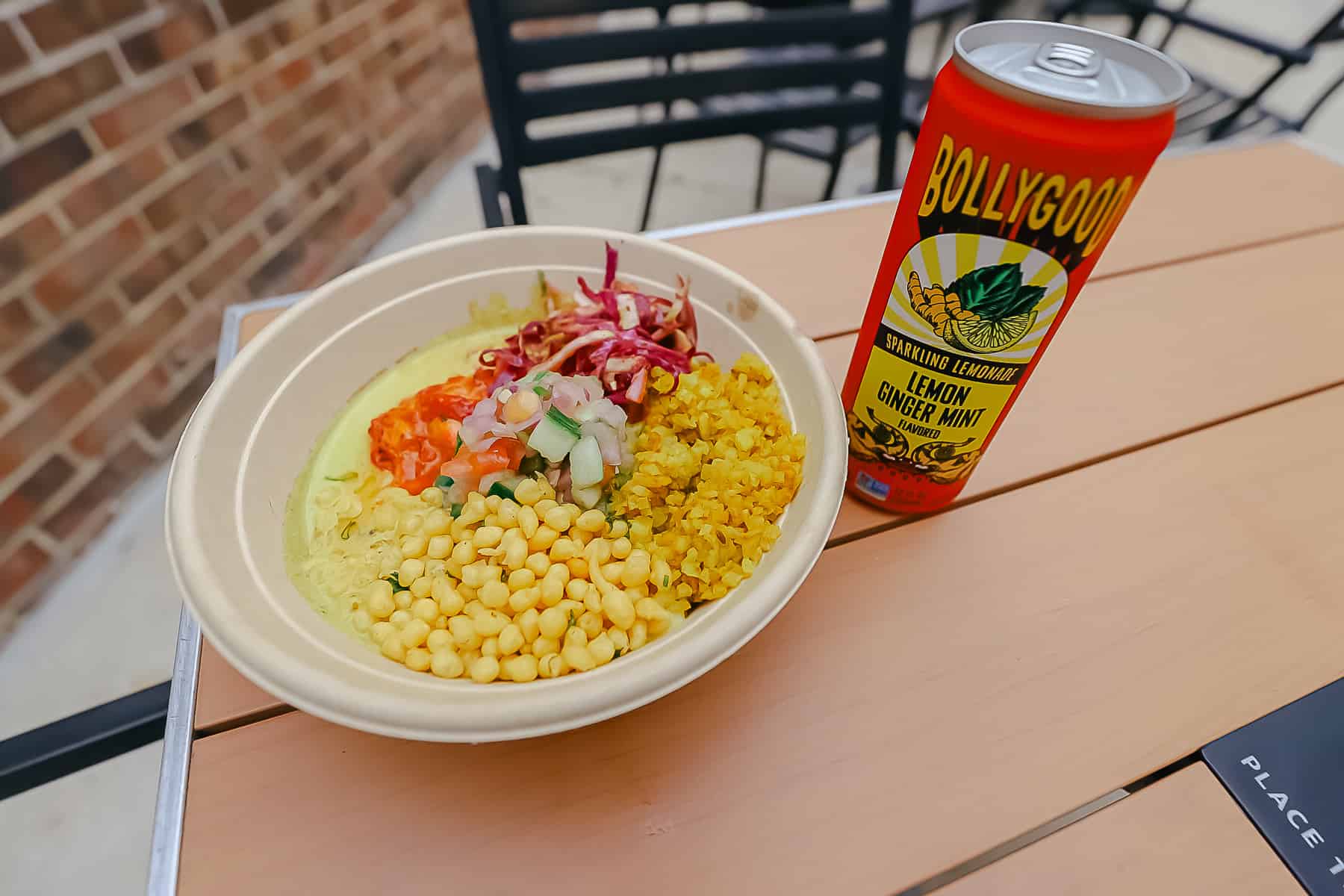 a bowl of tandoori chicken with rice and corn 