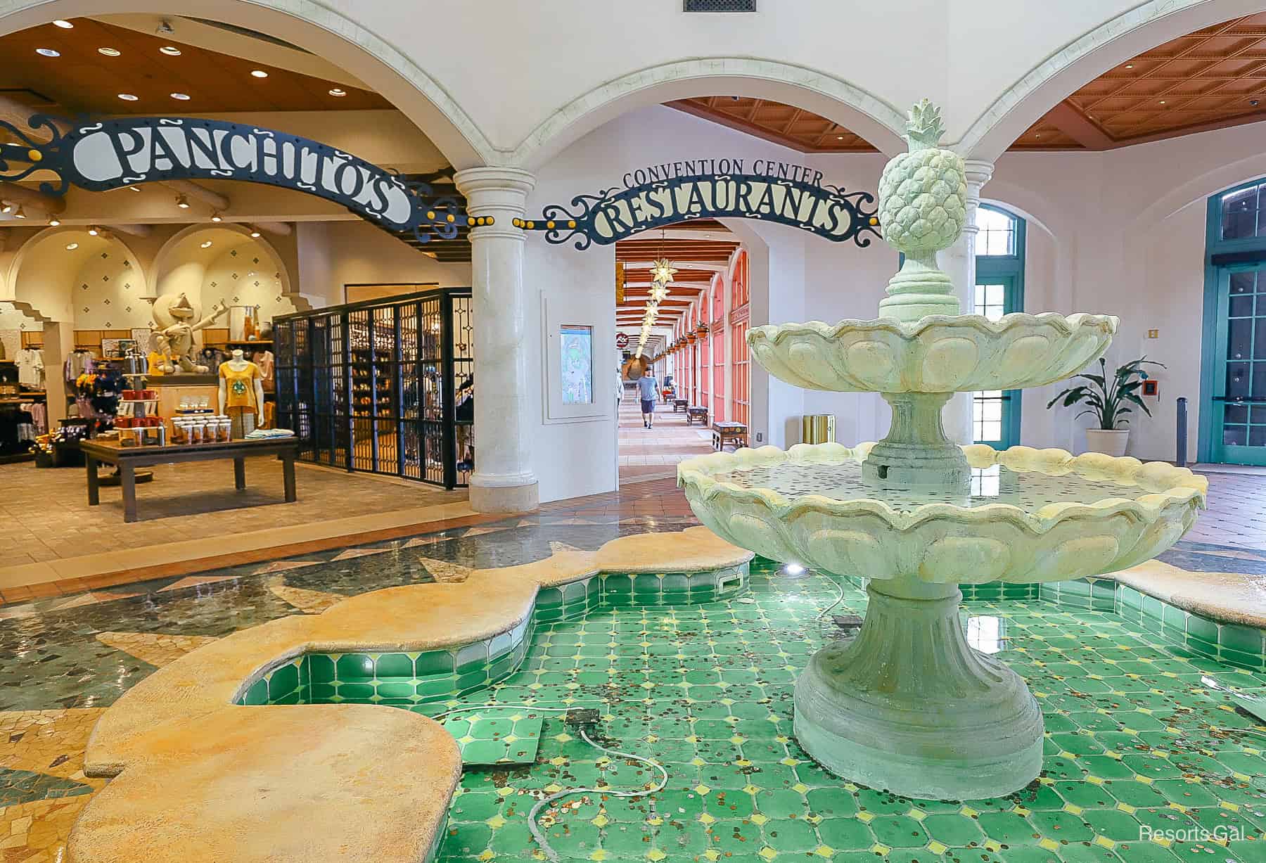 a closeup of the fountain in El Centro with signage for the gift shop, convention center, and restaurants