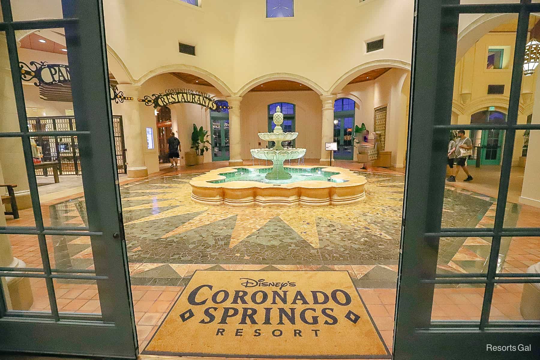 the sliding doors open to reveal a logo door mat that reads Disney's Coronado Springs Resort