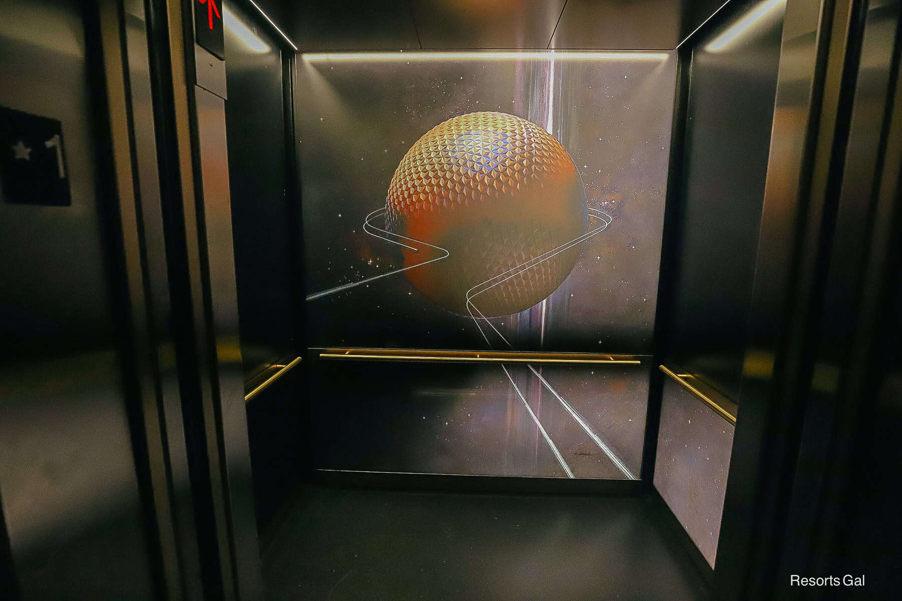 the elevator interior of GEO-82 features Spaceship Earth themed artwork 