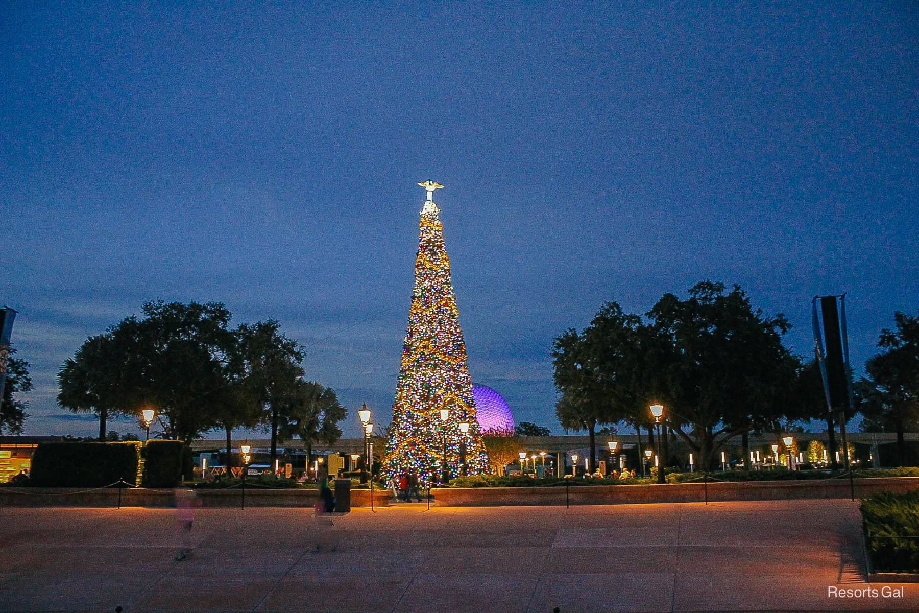 the Christmas tree topped with an angel represents the world at Epcot