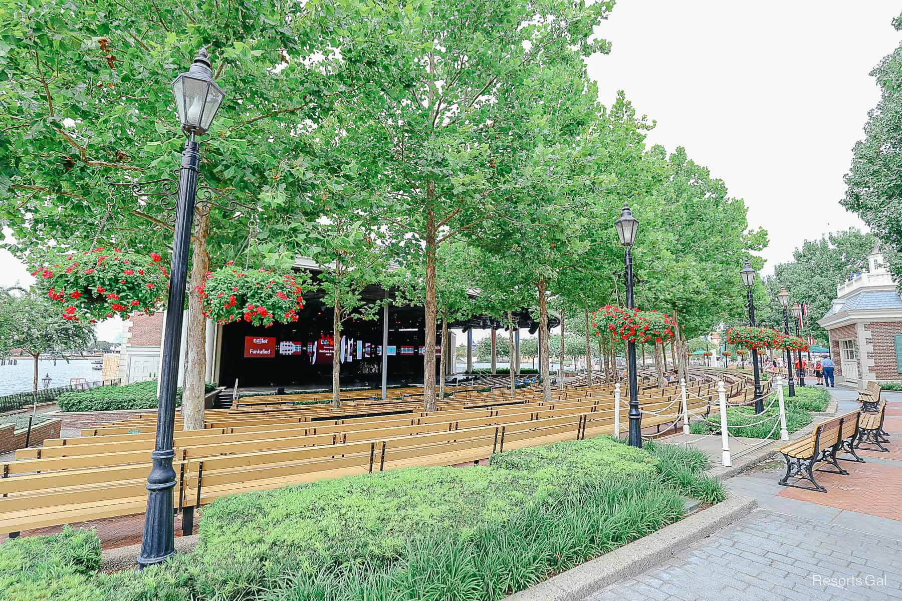 an outdoor theater with a stage and rows of benches 