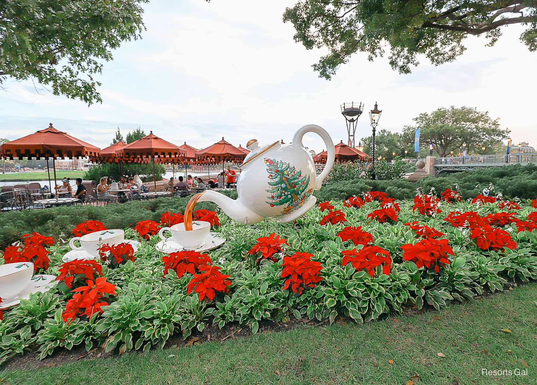 a holiday decorated tea cup in a garden at Epcot for the Festival of the Holidays