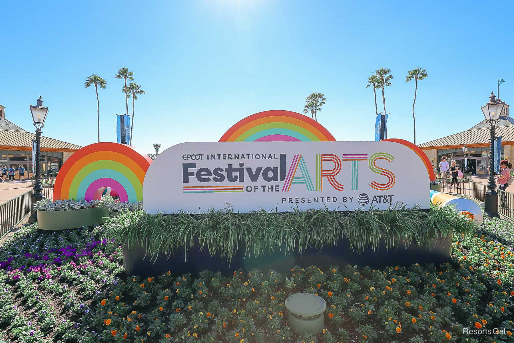 a sign for the Epcot International Festival of the Arts with rainbows