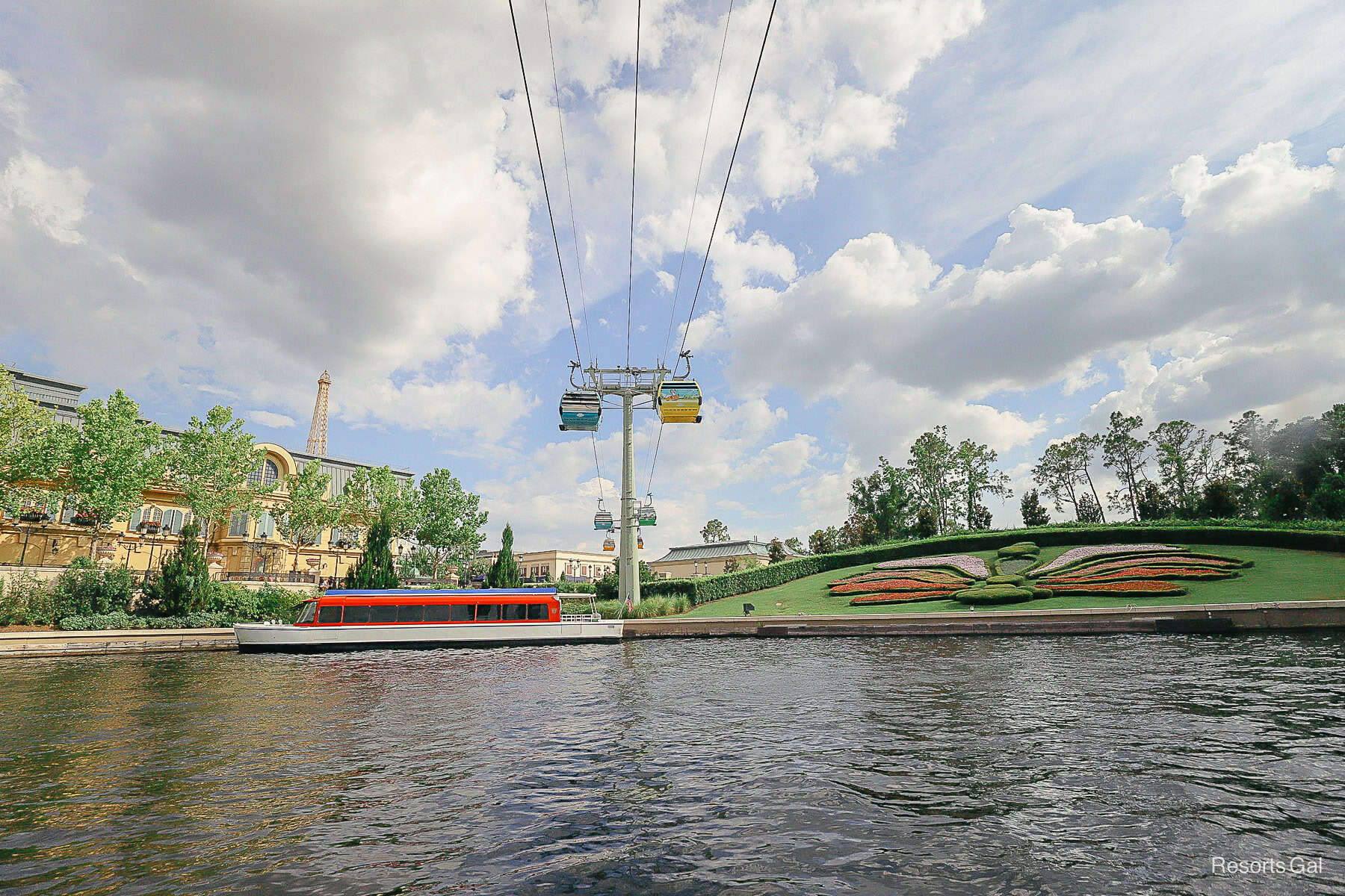 The Skyliner passing over the boat at Epcot's International Gateway entrance 