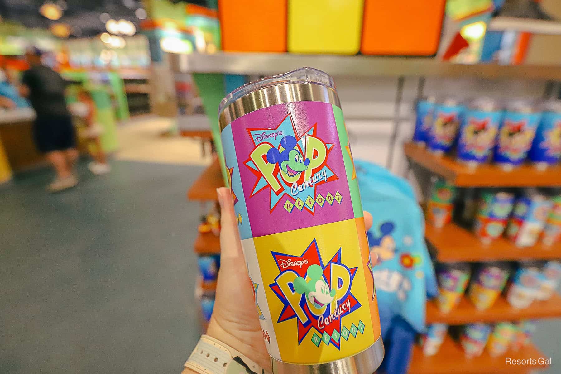 the opposite side of the Pop Century tumbler with purple and yellow squares 