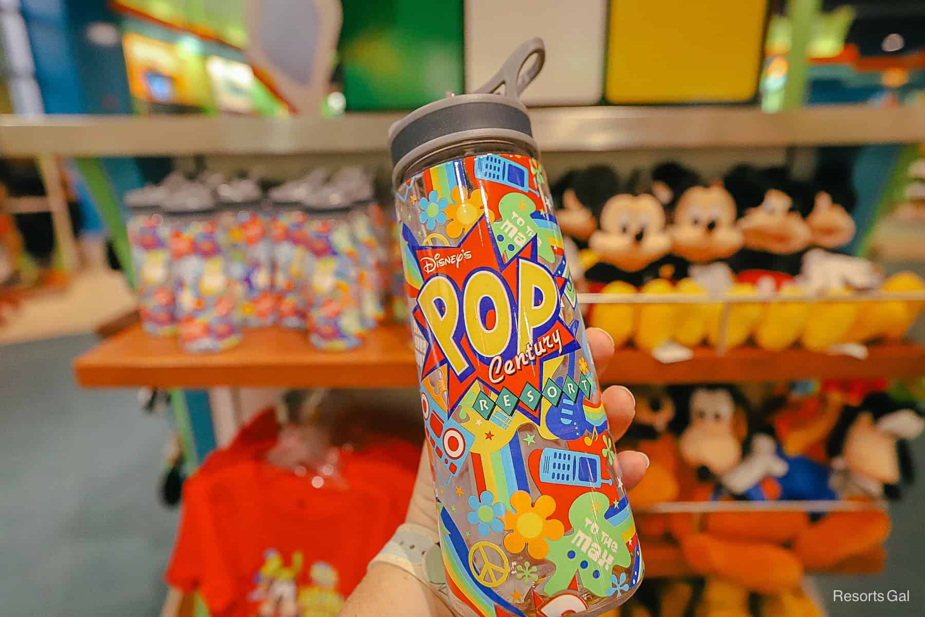 a clear tumbler that's covered in a Pop Century Resort print 