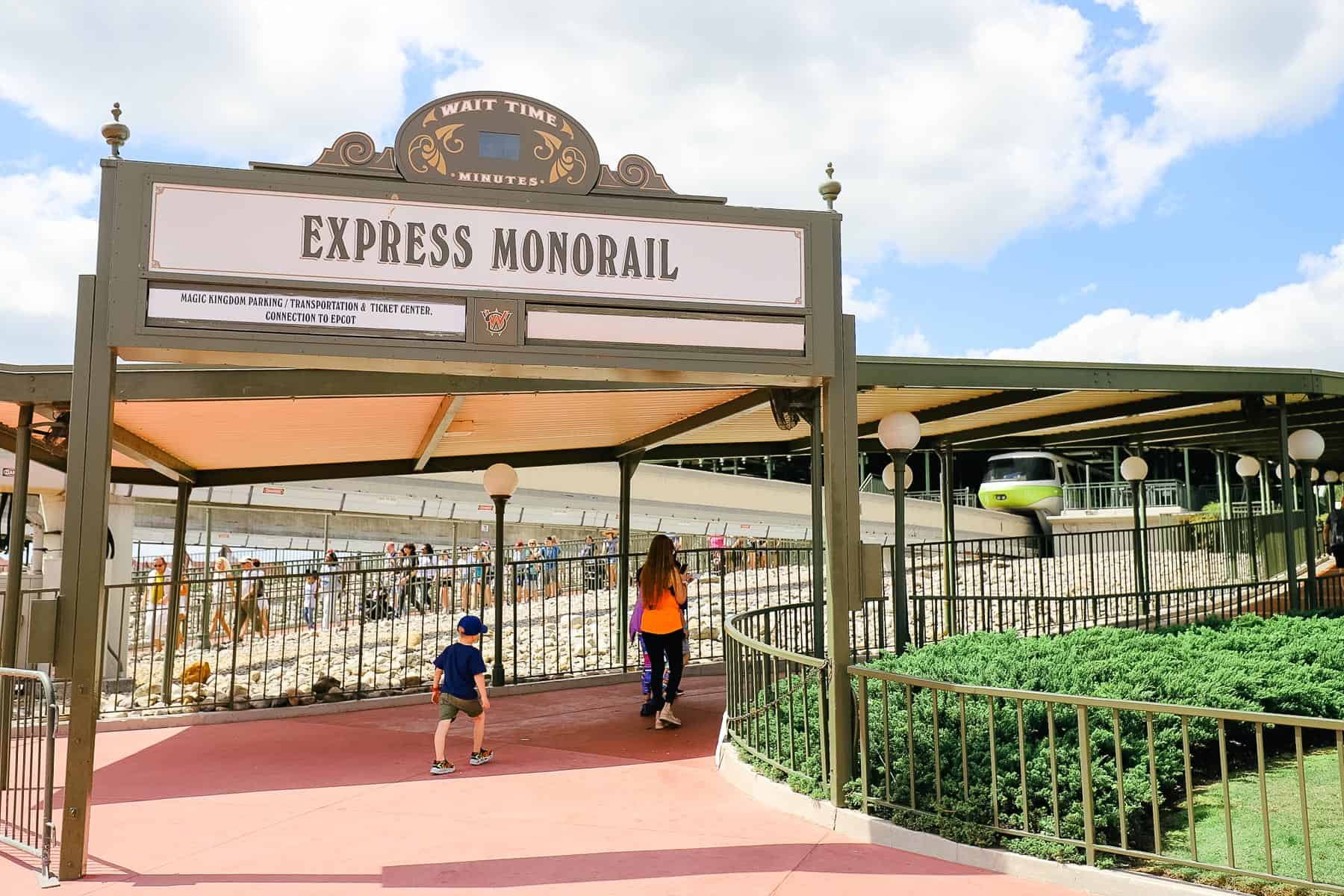 Guests walking up the ramp to board the express monorail at Magic Kingdom. 