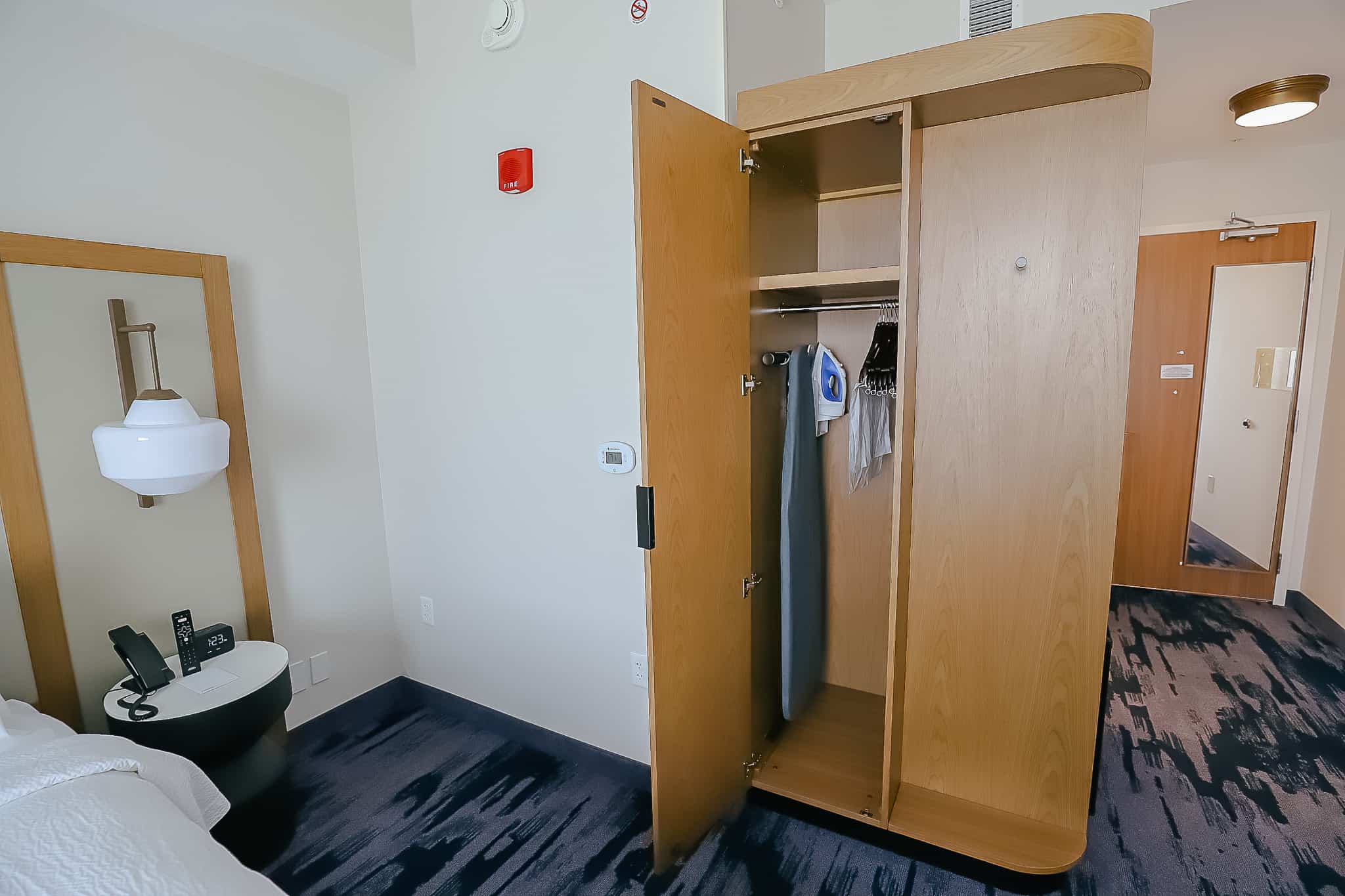 closet with iron and ironing board 