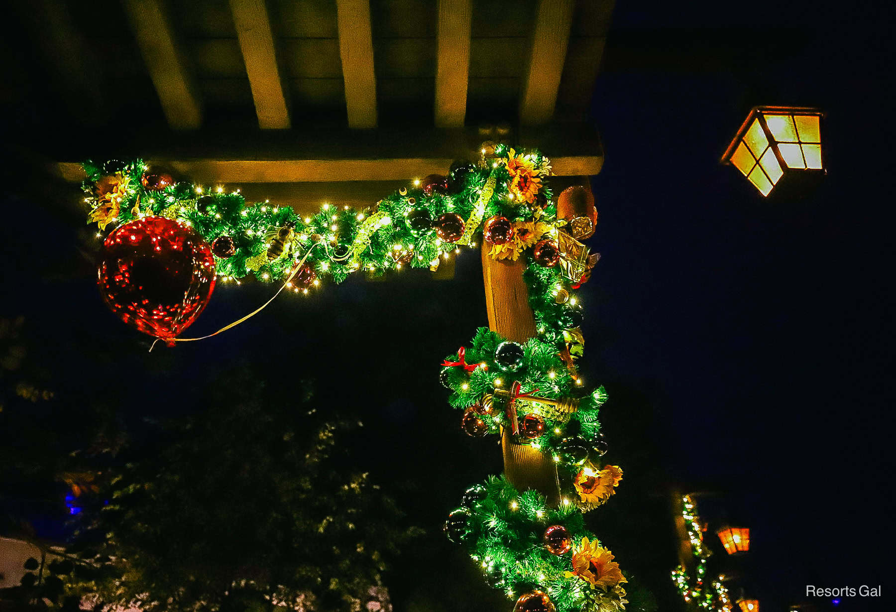 Winnie the Pooh's red Christmas balloon at night in Fantasyland at Magic Kingdom 