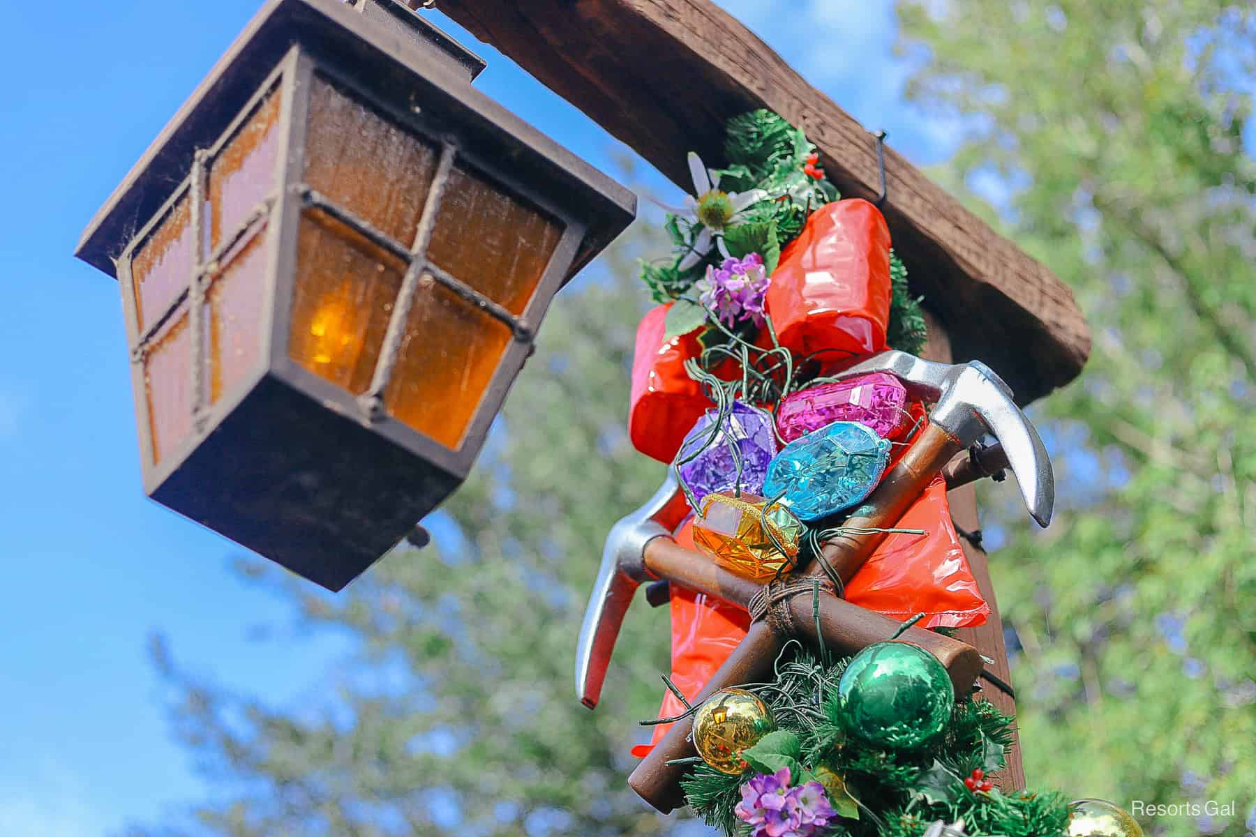 a close up of the two bows on the lamp post with a crossed pick axes representing the Seven Dwarfs and their mine 