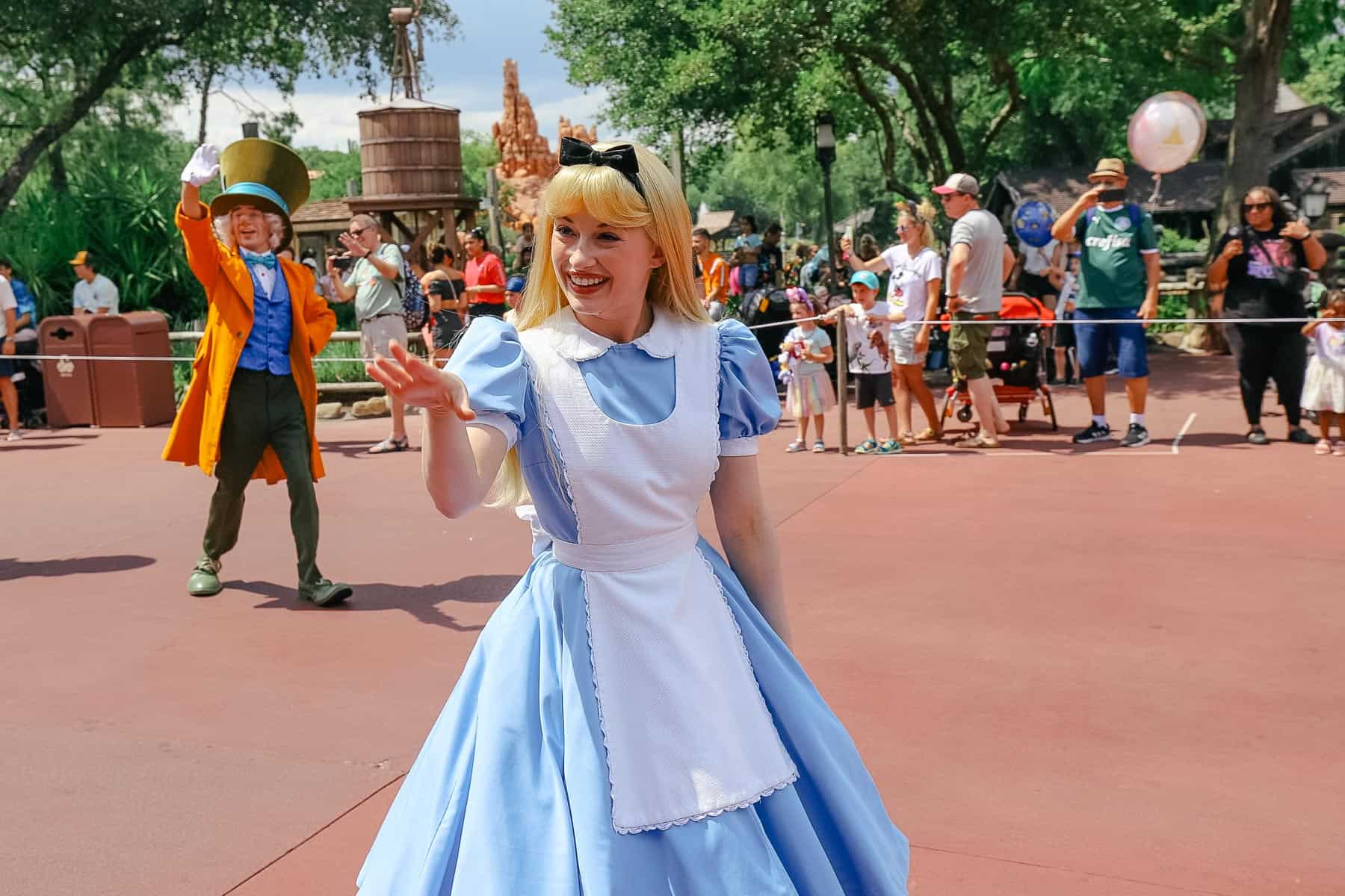 Alice in Wonderland waves to guests along the parade route. 