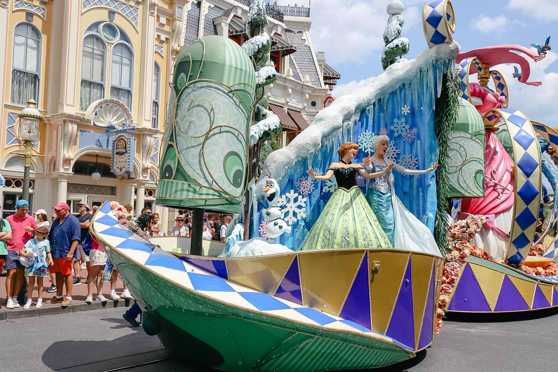 Anna and Elsa come down the Main Street USA portion of the parade route at Magic Kingdom. 
