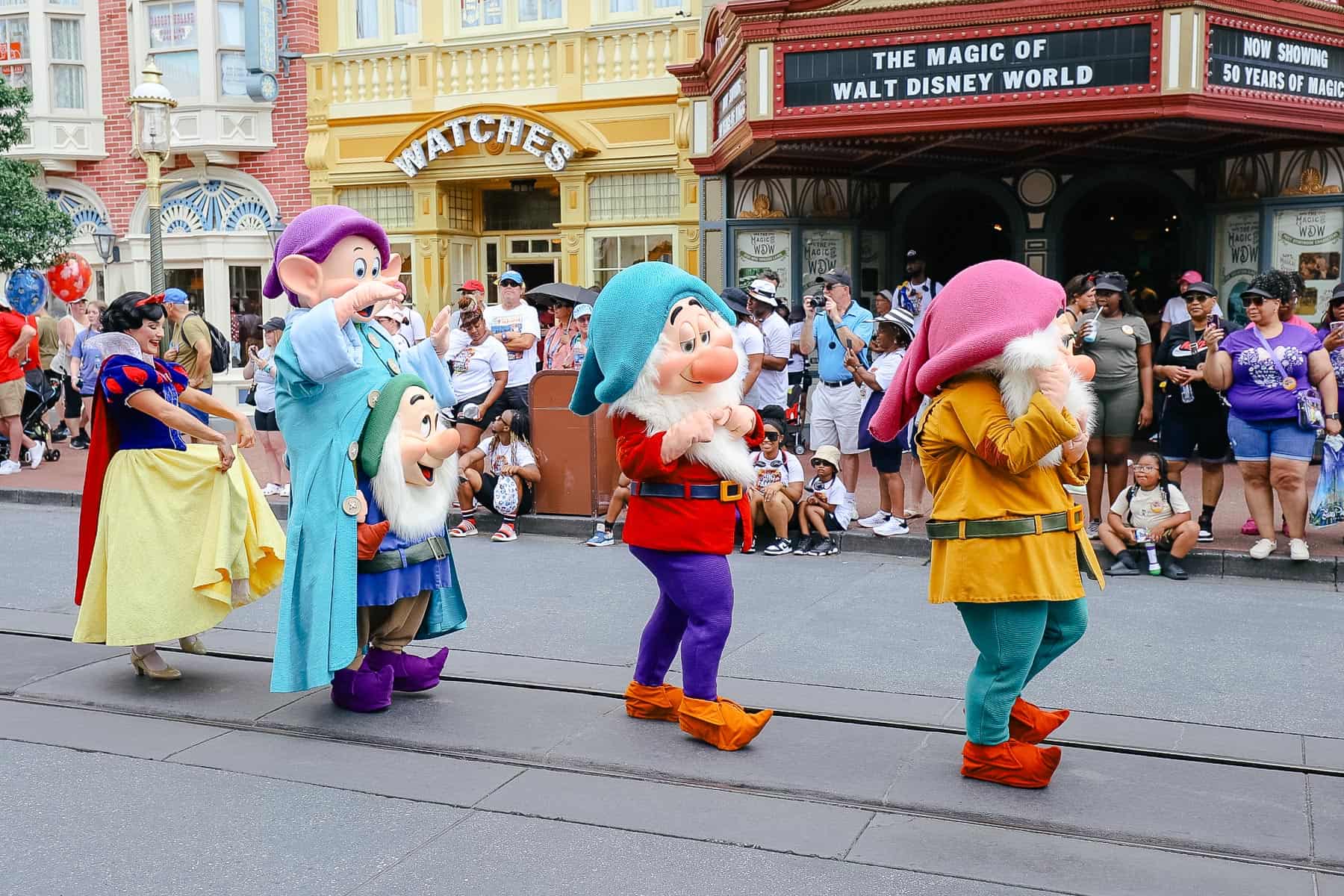 Snow White and the Seven Dwarfs walk in the parade at Magic Kingdom. 