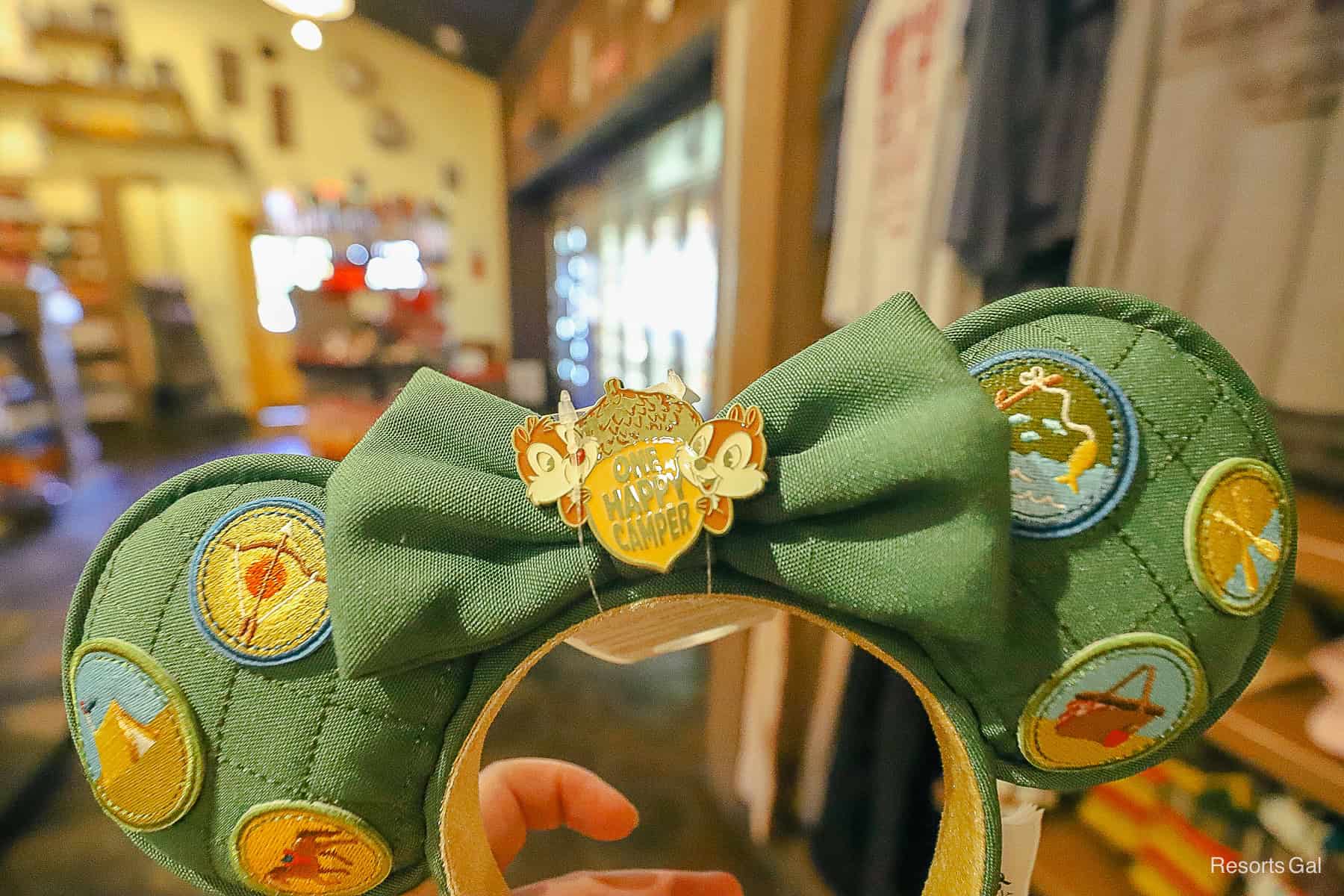 a green pair of fabric ears with a One Happy Camper Pin with Chip and Dale