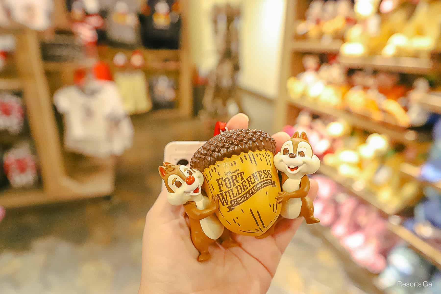 an acorn ornament with Fort Wilderness logo and Chip and Dale on each side
