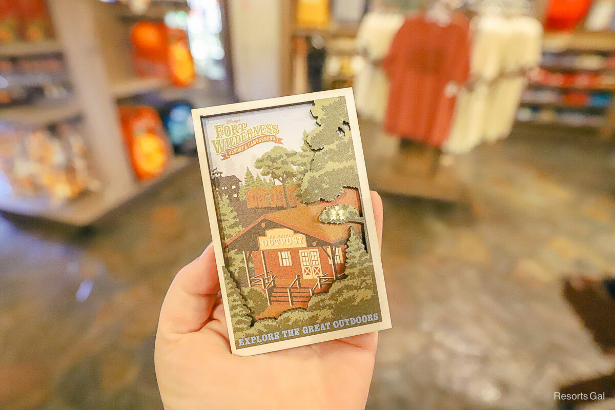 a magnet with the resort logo and the Outpost building