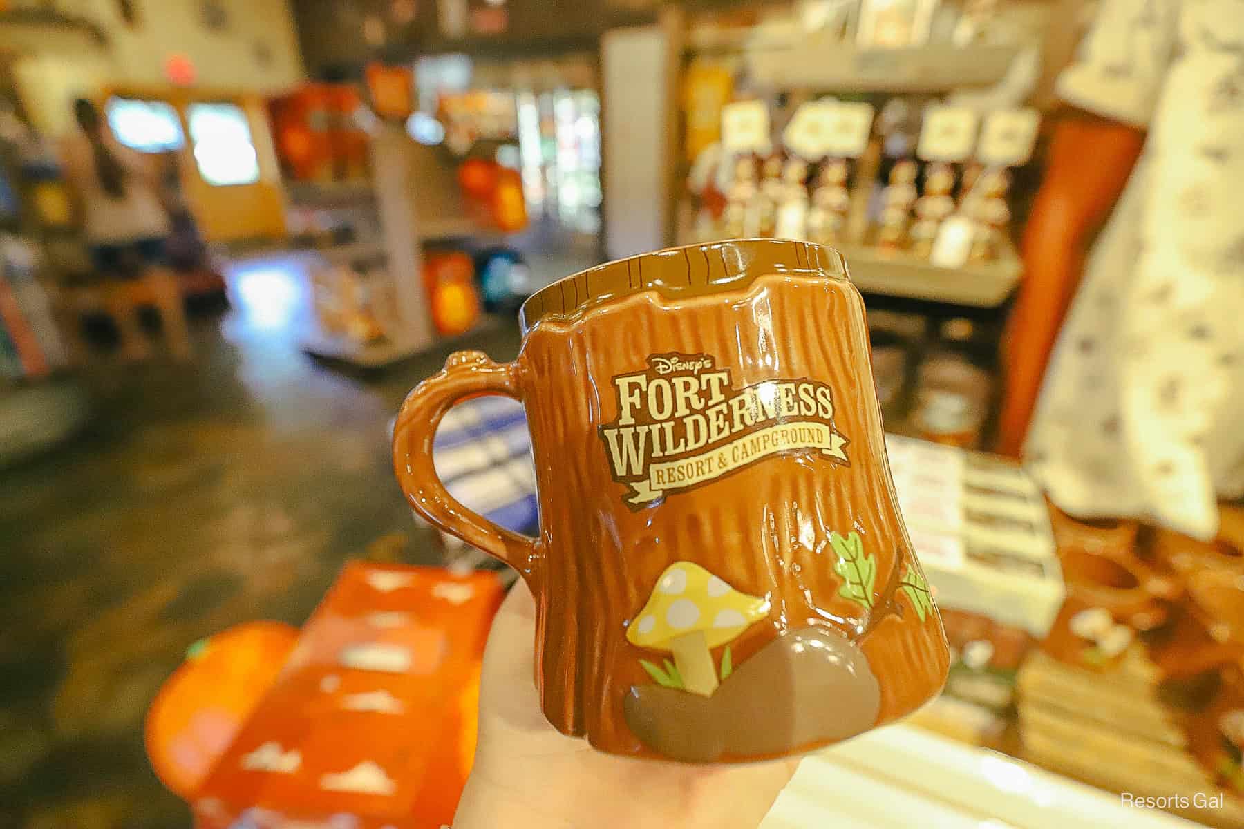 a mug that resembles a wooden stump with the Fort Wilderness logo
