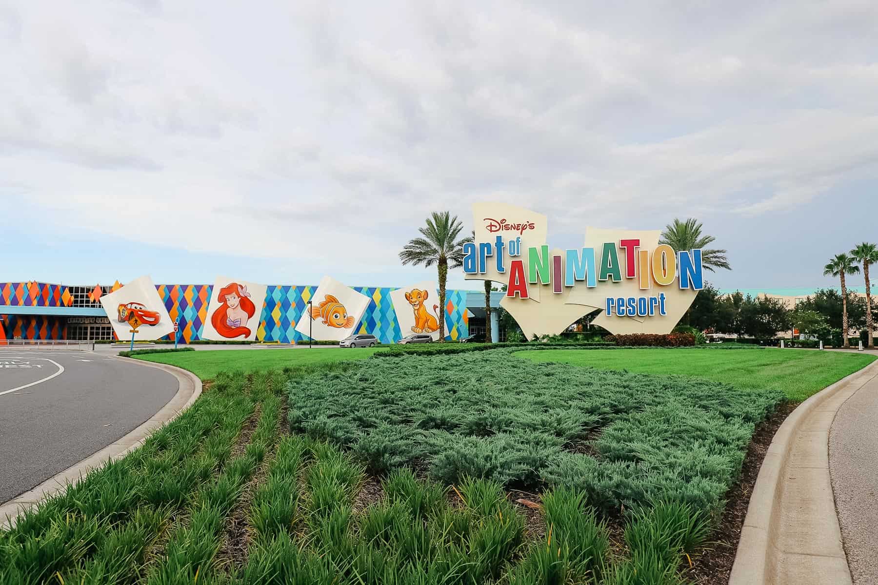 a giant picture of Lightning McQueen, Ariel, Nemo, and Simba at the entrance of Art of Animation. 