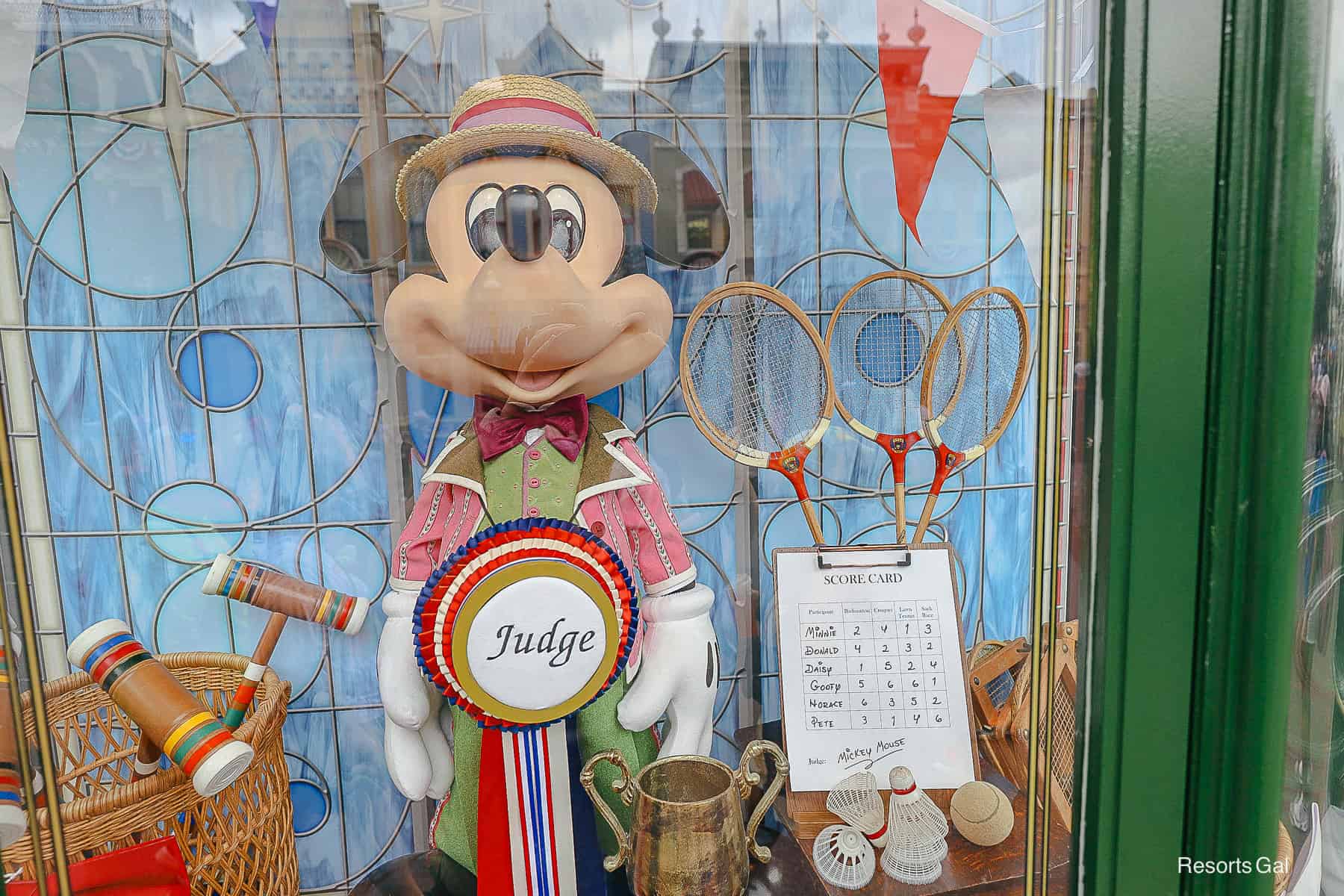a closeup of Mickey shows he is the judge of the 4th of July festivities and games 