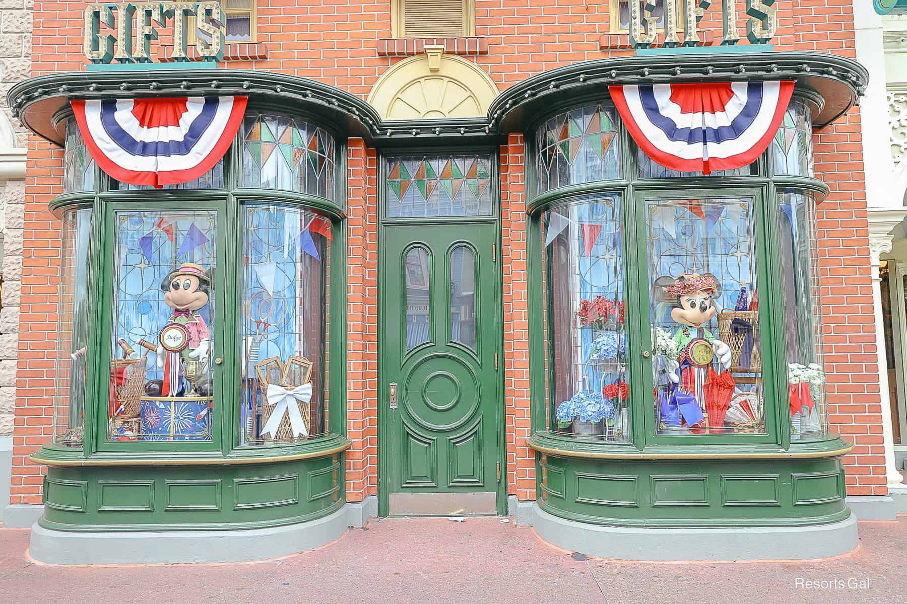 a patriotic window display featuring Mickey on the left and Minnie on the right 