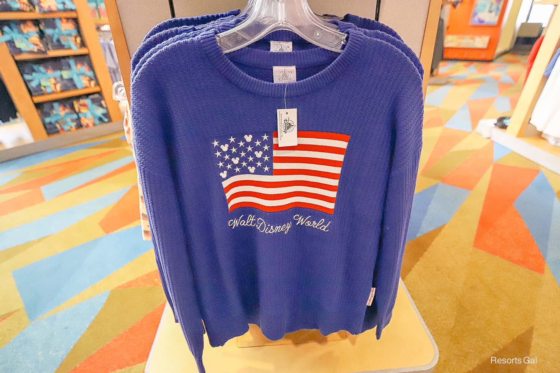 blue cable knit sweater centered with the American flag and Walt Disney World logo 