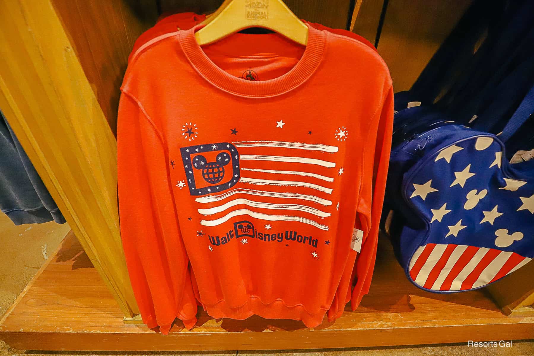 a red sweatshirt with the American flag and Walt Disney World logo 