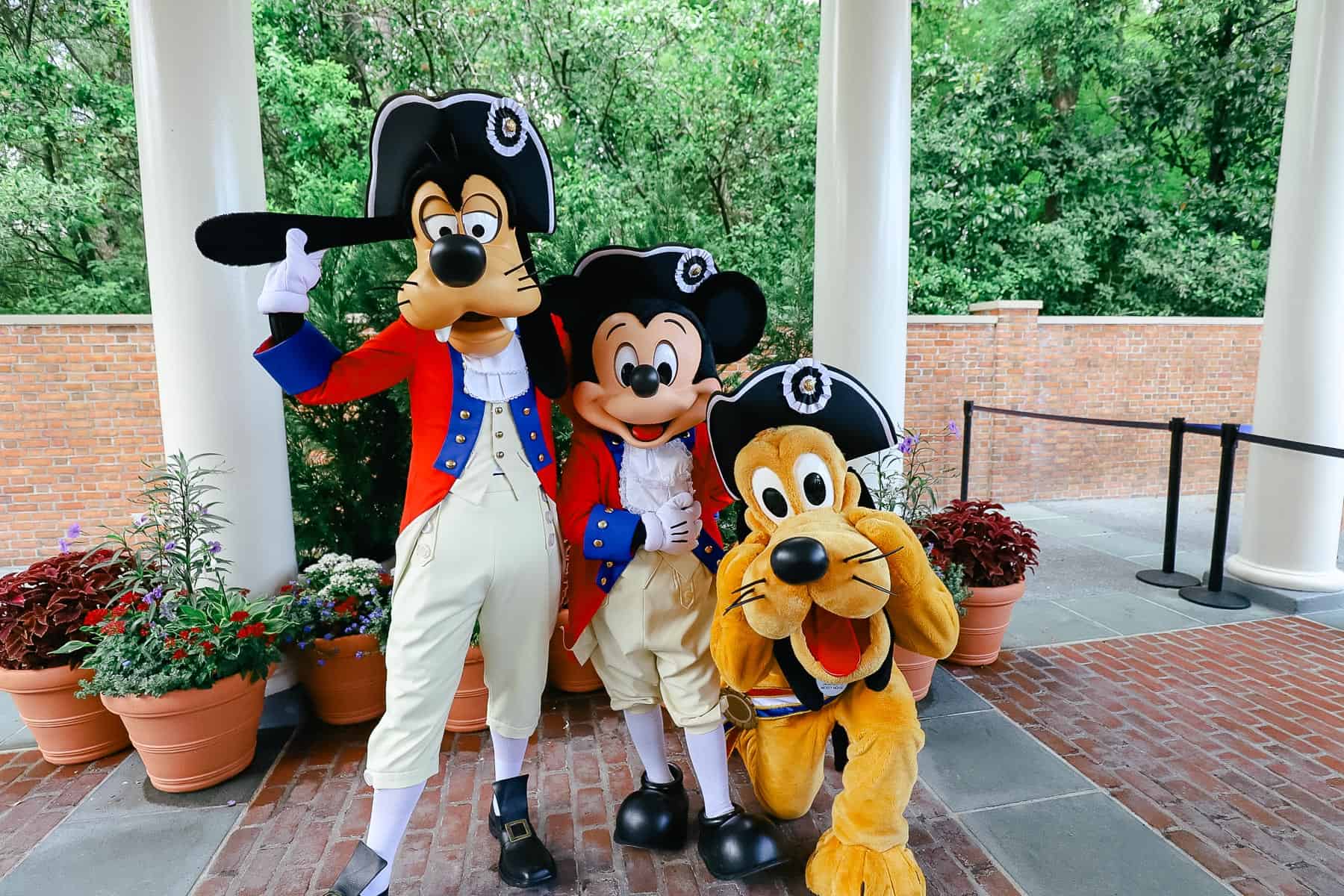 Goofy, Mickey and Pluto wearing patriotic costumes to celebrate July at Disney World 