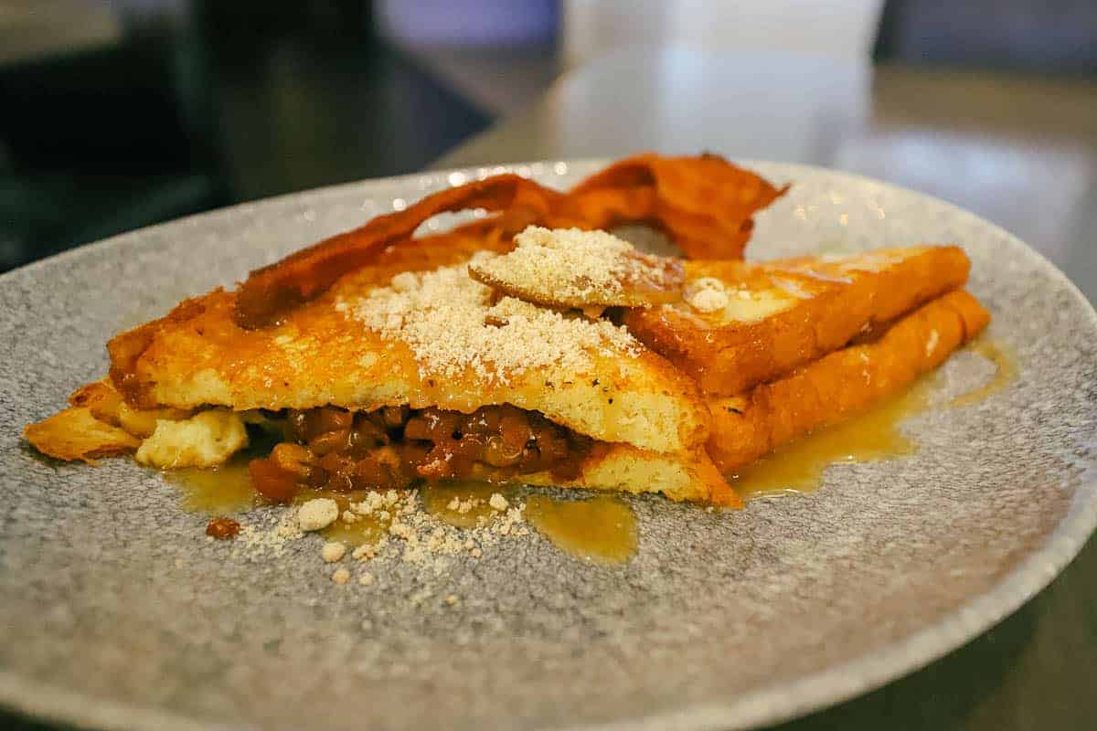 a platter with French Toast stuffed with caramel apples and bacon 