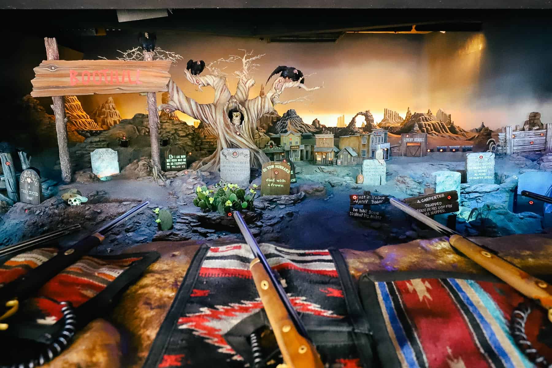 A replica of Boot Hill Cemetery serves as the backdrop for the Frontierland Shootin' Arcade. 