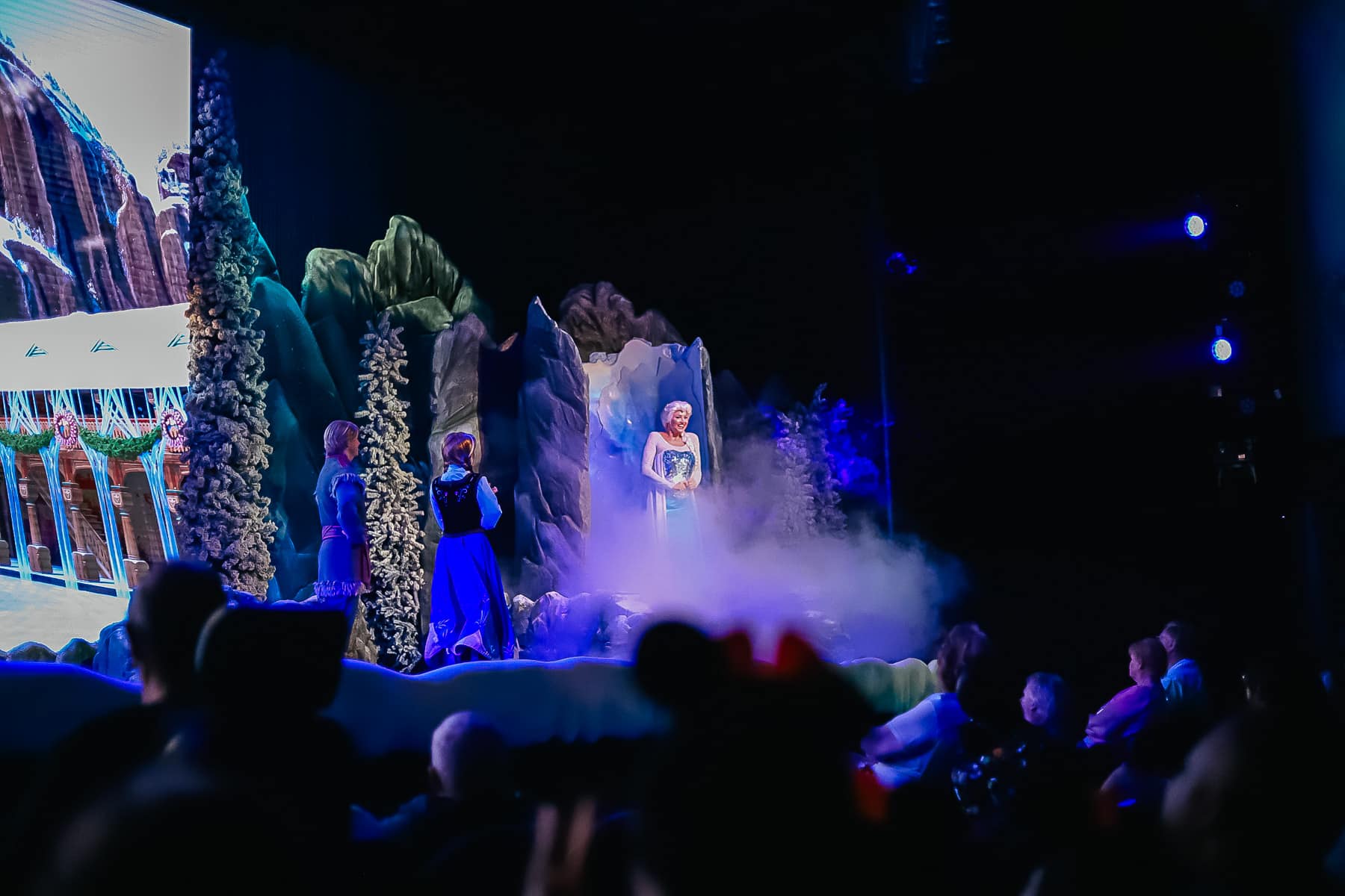 Elsa joins the stage as smoke reveals her. 