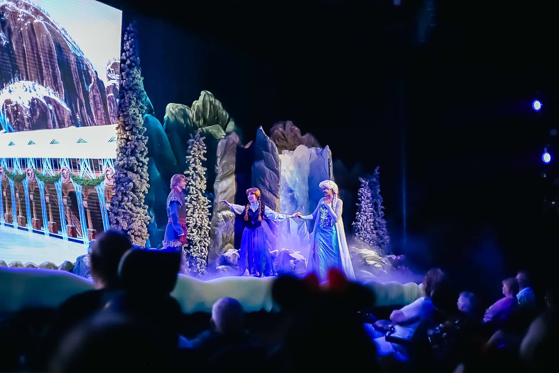 Elsa greets Anna on stage. 