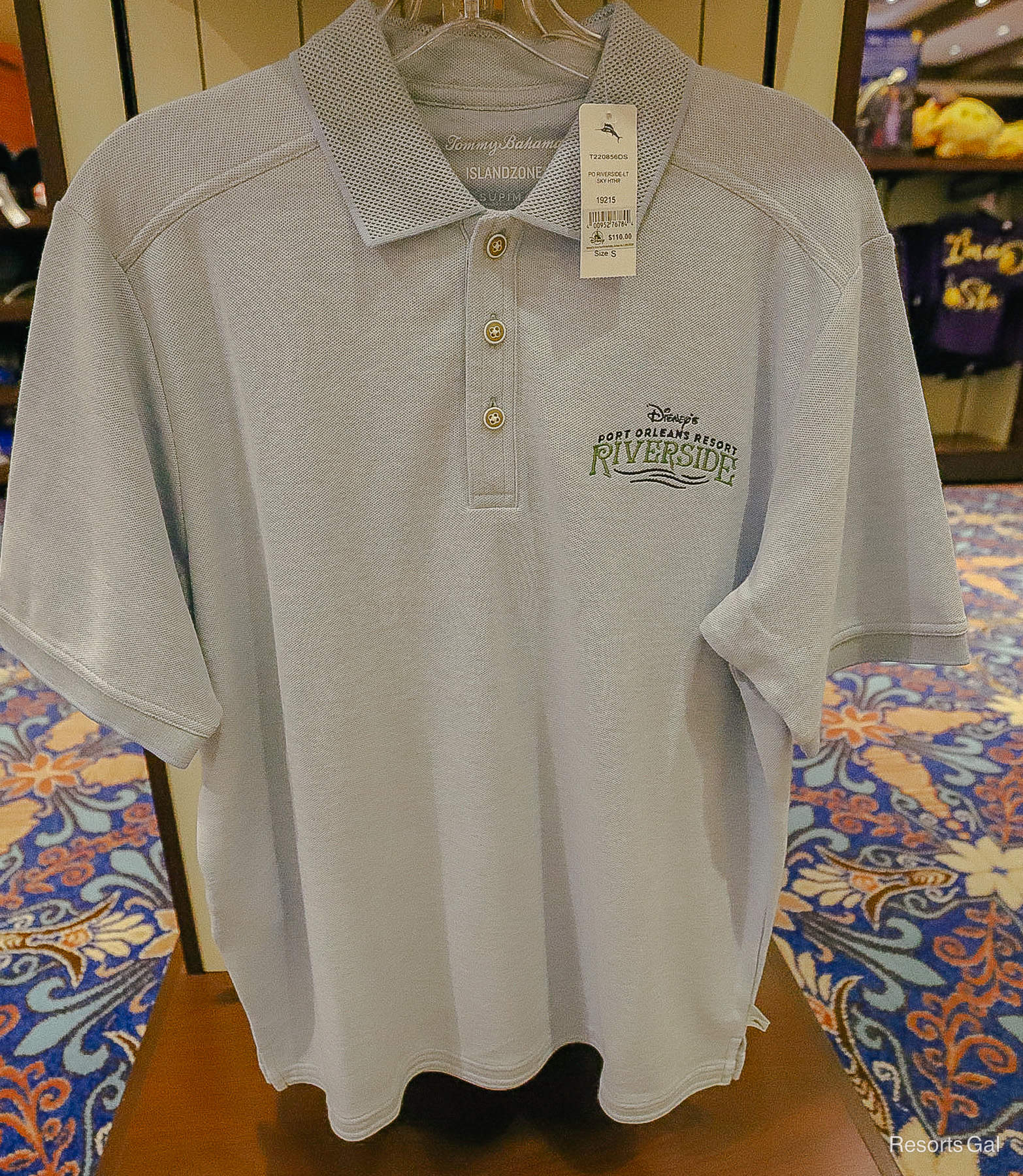 a polo shirt in light blue by Tommy Bahamas with the Port Orleans Riverside logo 