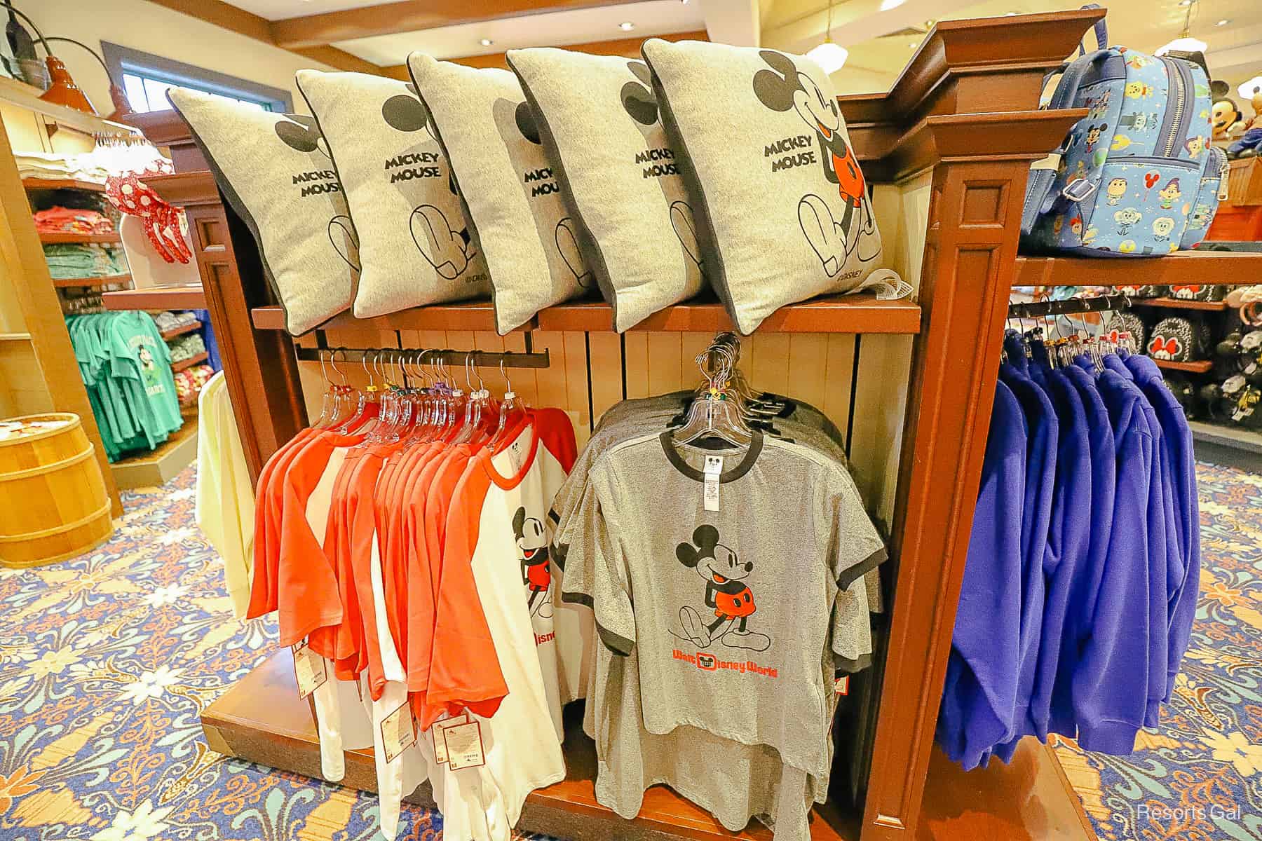 a display of shirts and pillows with Mickey Mouse 