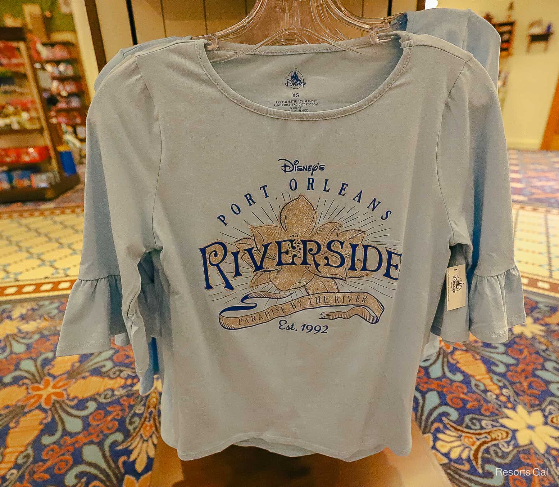 the Port Orleans Riverside logo on a women's dressy shirt that's blue 