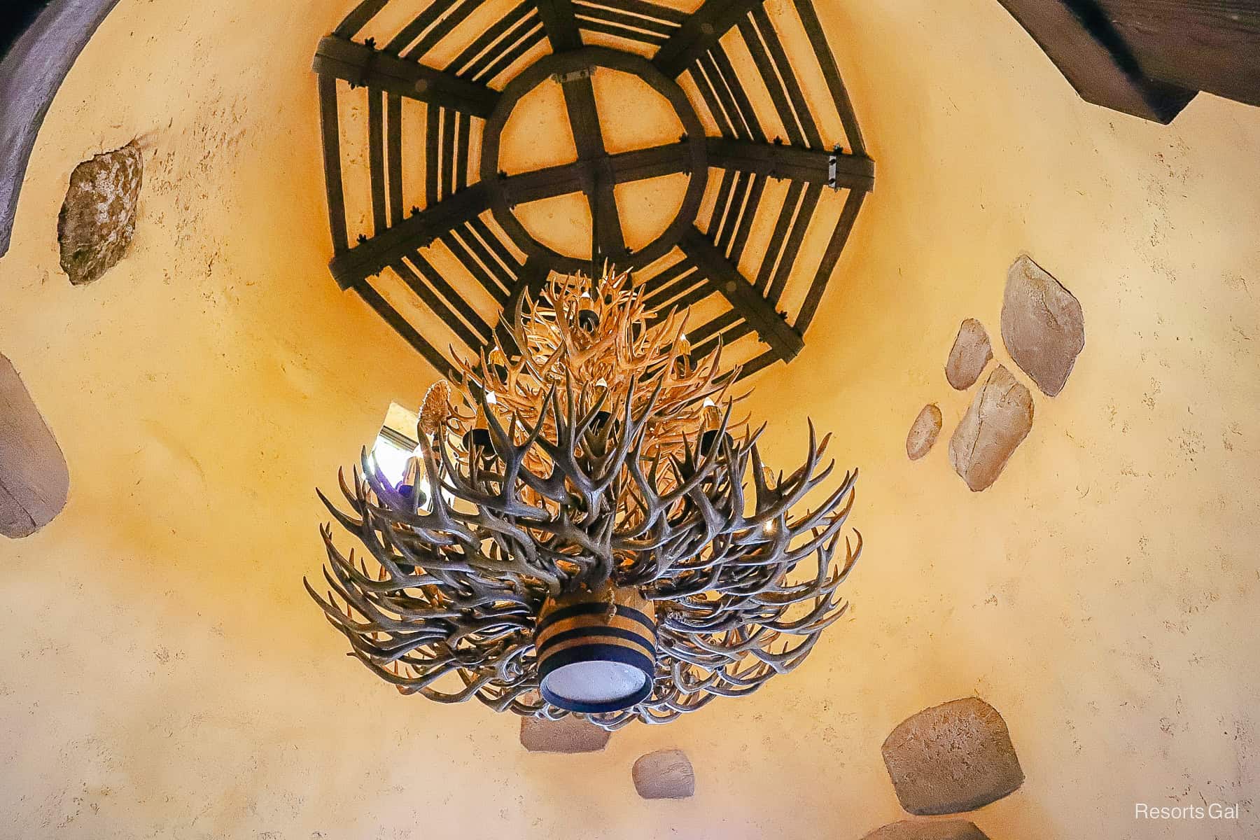 a chandelier made of antlers with a barrel base 