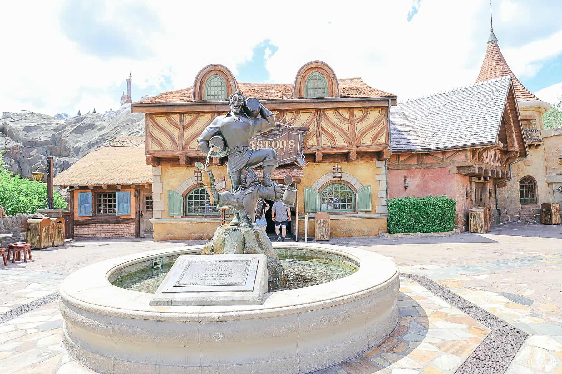 the fountain outside of Gaston's Tavern with a statue of Gaston an LeFou
