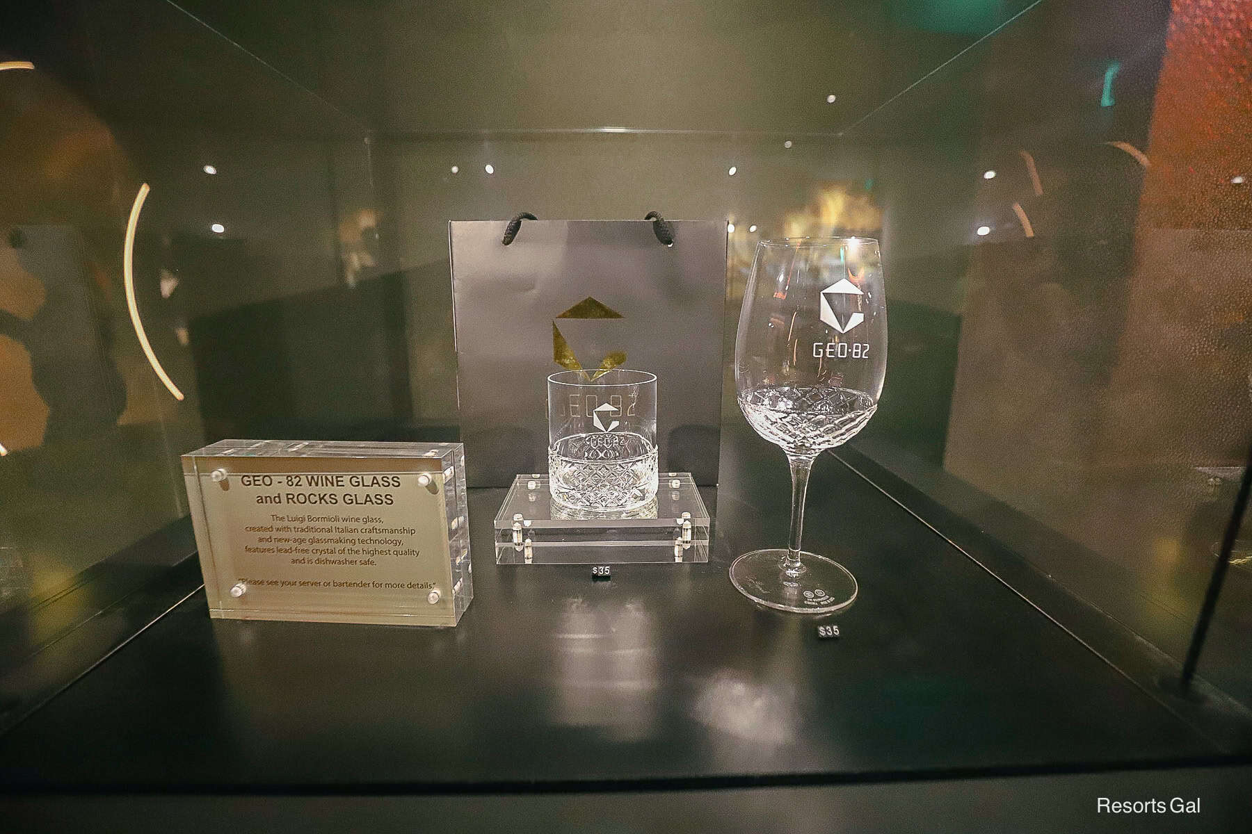 a display case with the GEO-82 Wine Glass and Rocks Glass that's available for purchase 