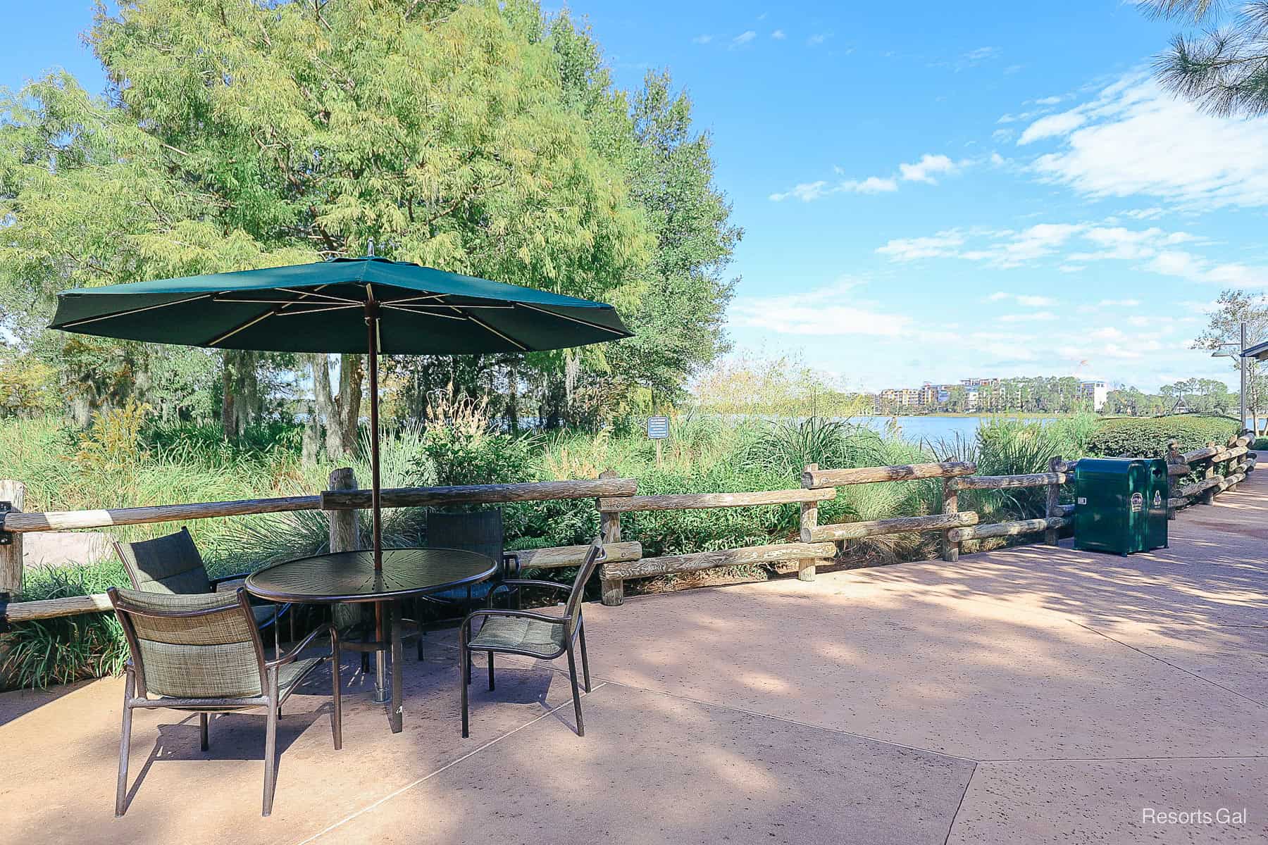 a table and chairs with an umbrella near the restaurant 