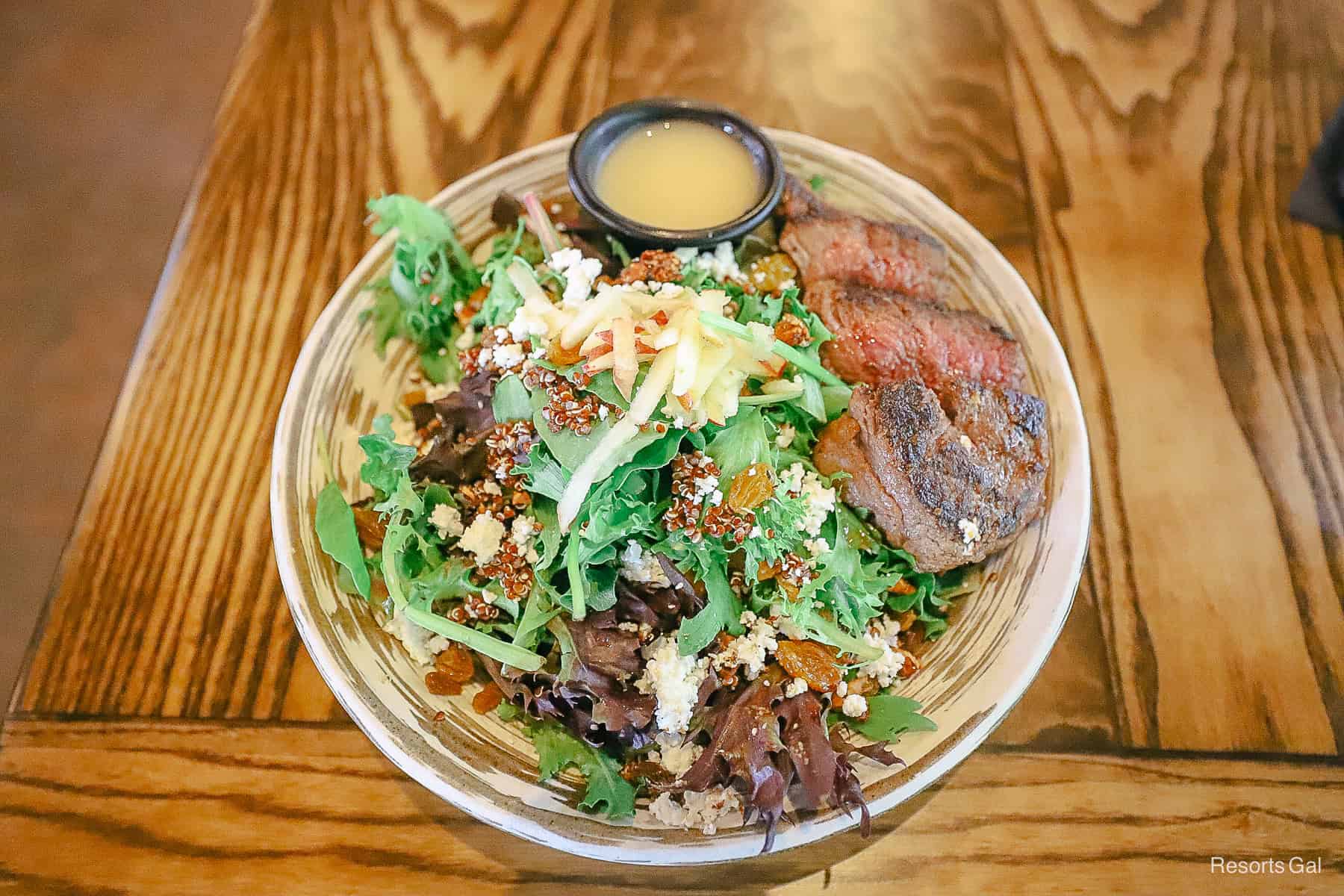 the salad is topped with apples, goat cheese, and quinoa 