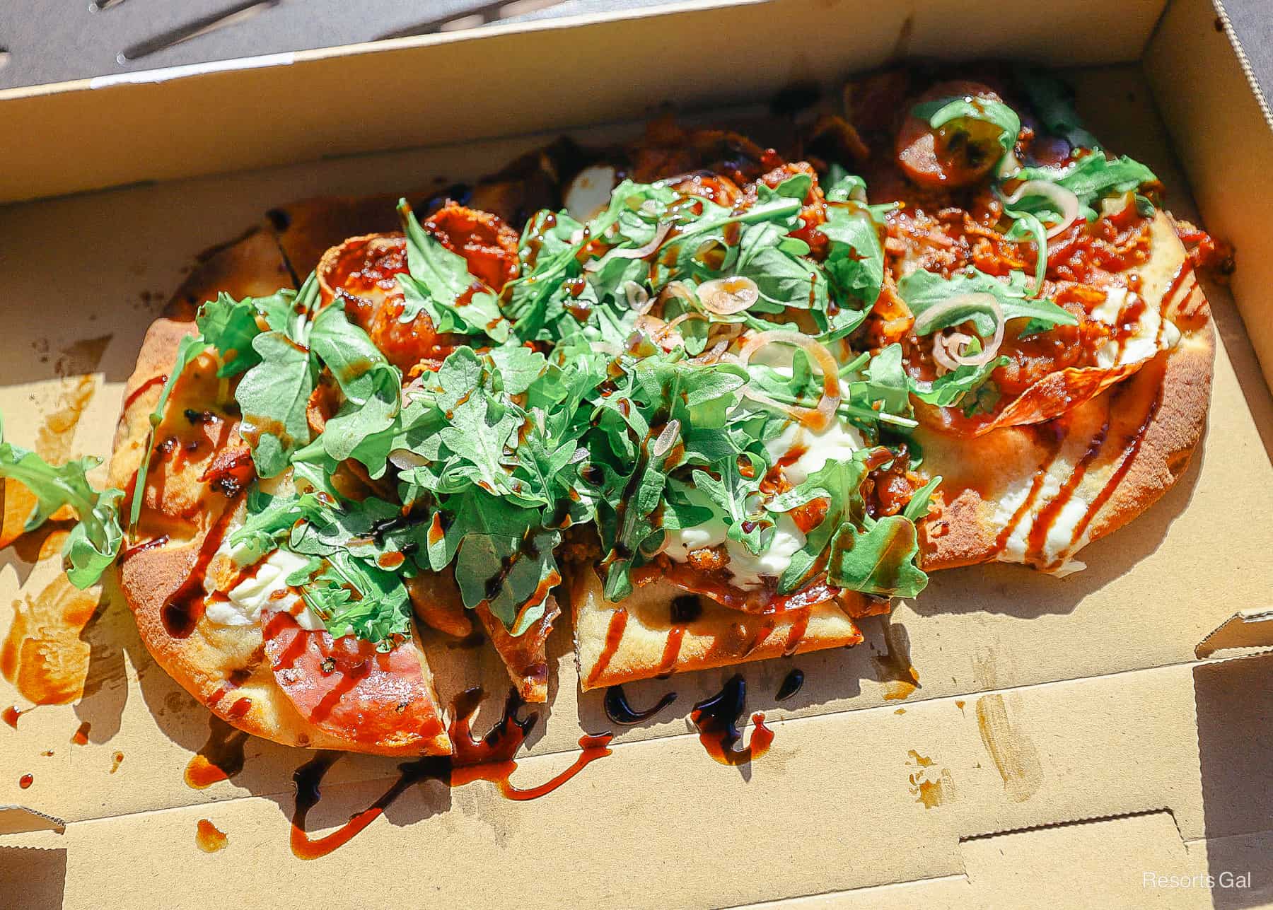 a flatbread pizza from the poolside bar topped with arugula 