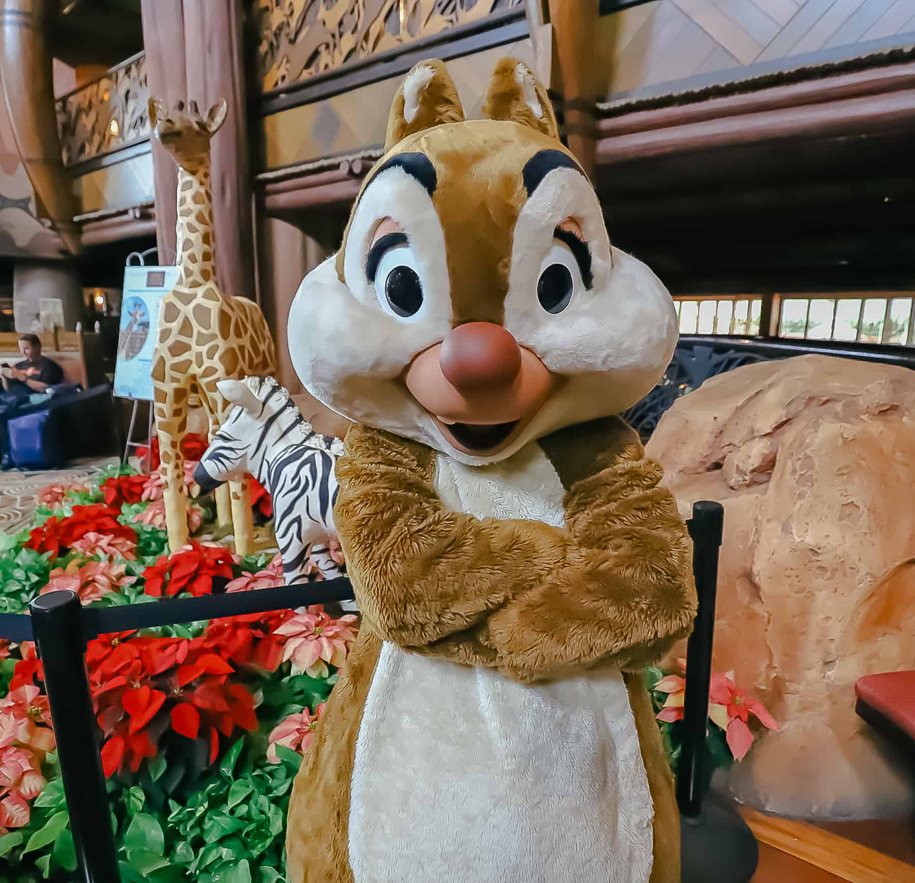 Dale of Chip and Dale poses for a photo near the gingerbread display. 