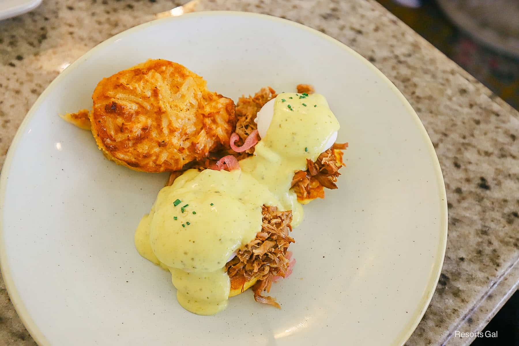 a plate with hash brown casserole and eggs Benedict