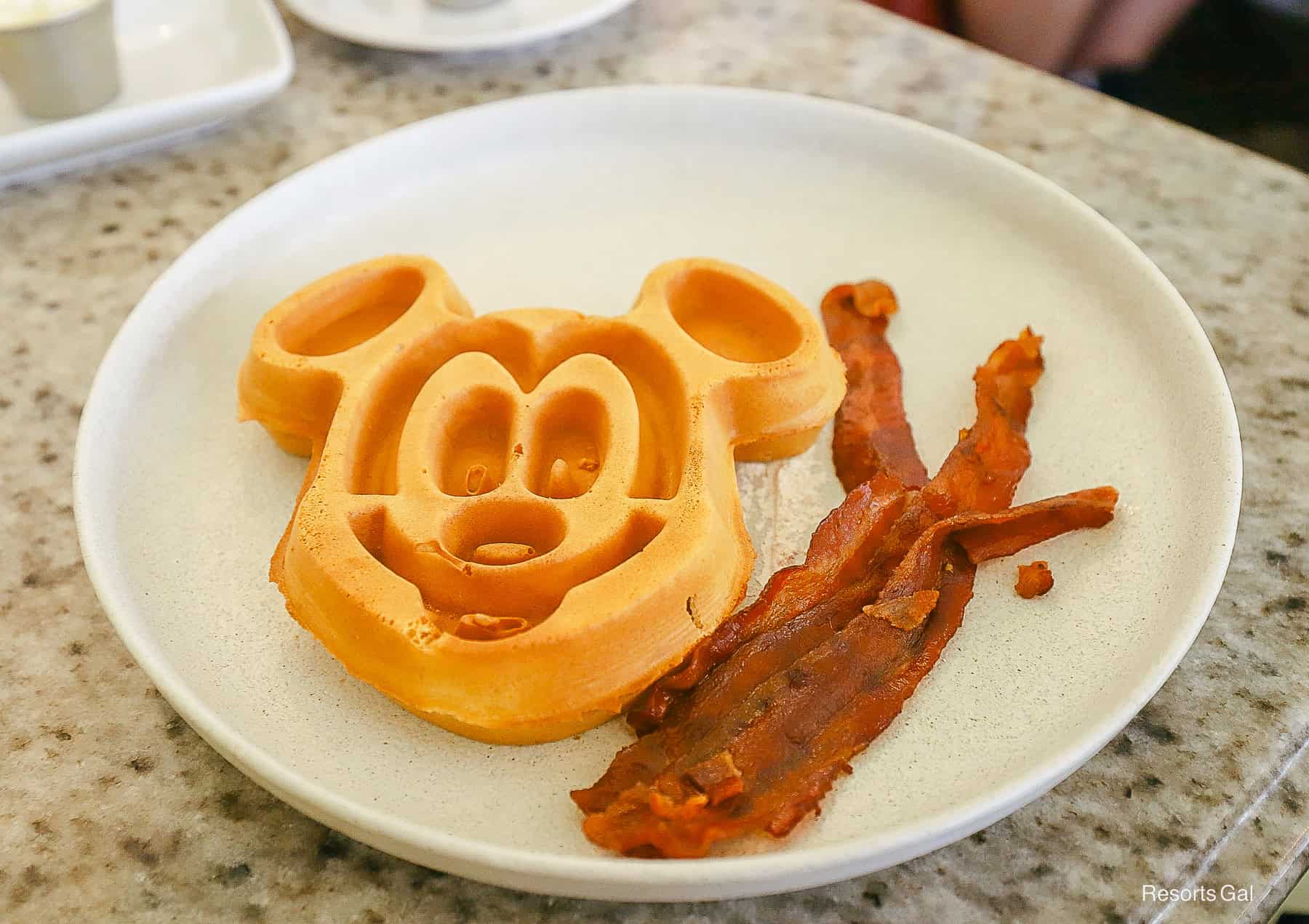 a child's Mickey waffle with an order of bacon