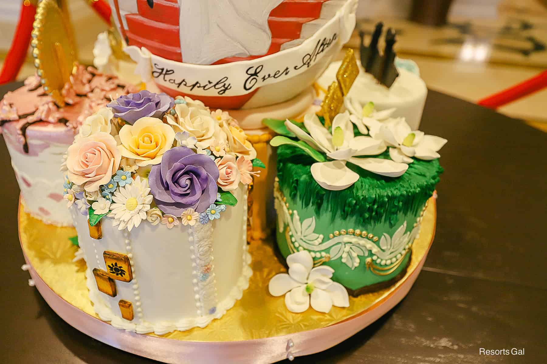 the egg is surrounded by small cakes representing Disney princesses