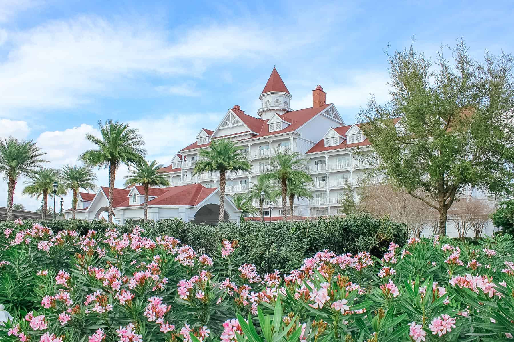 The Grand Floridian Villas building with pink flowers in bloom. 