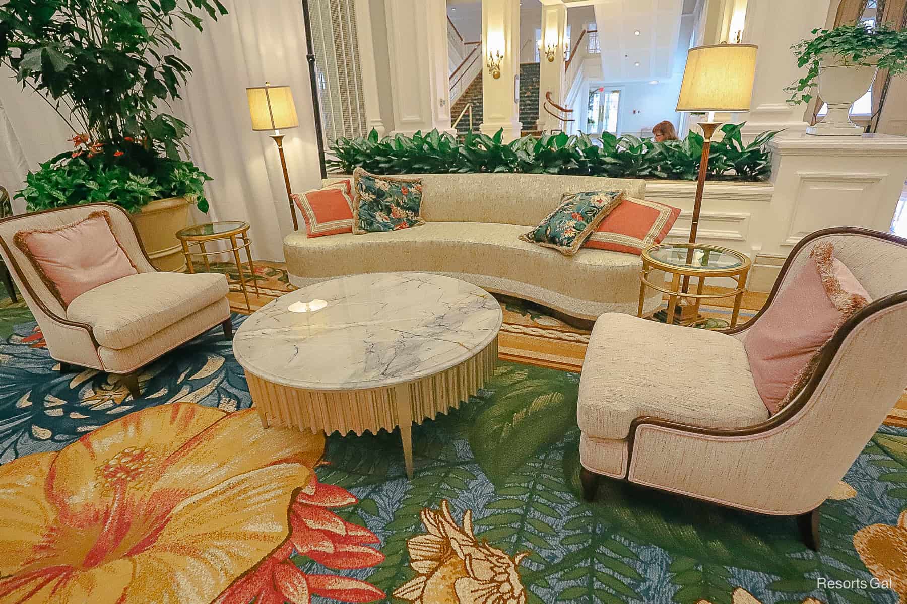 a settee with a round coffee table make up the new furnishings in the Grand Floridian's lobby 