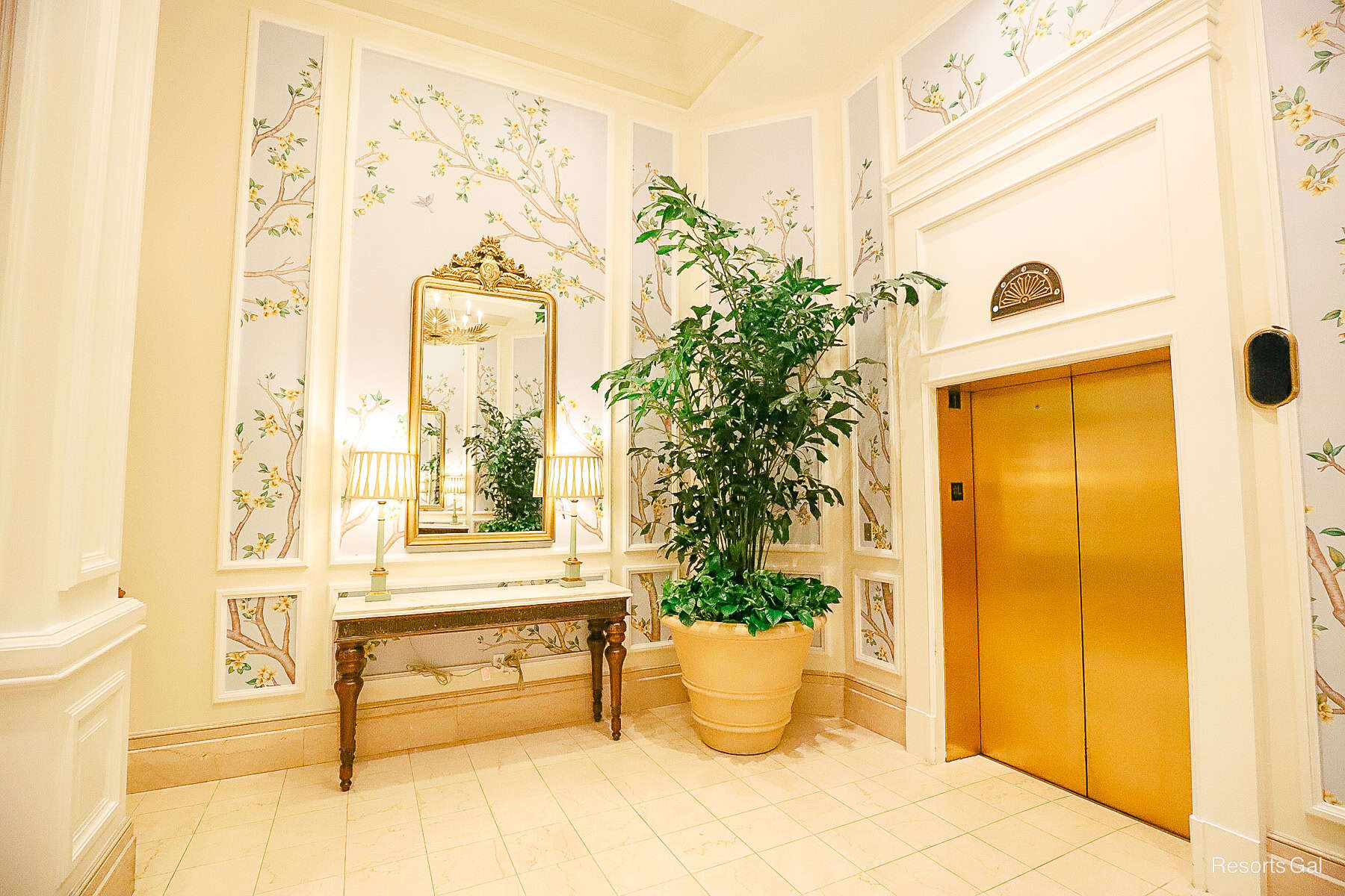 a side view that shows trees and murals in the elevator lobby