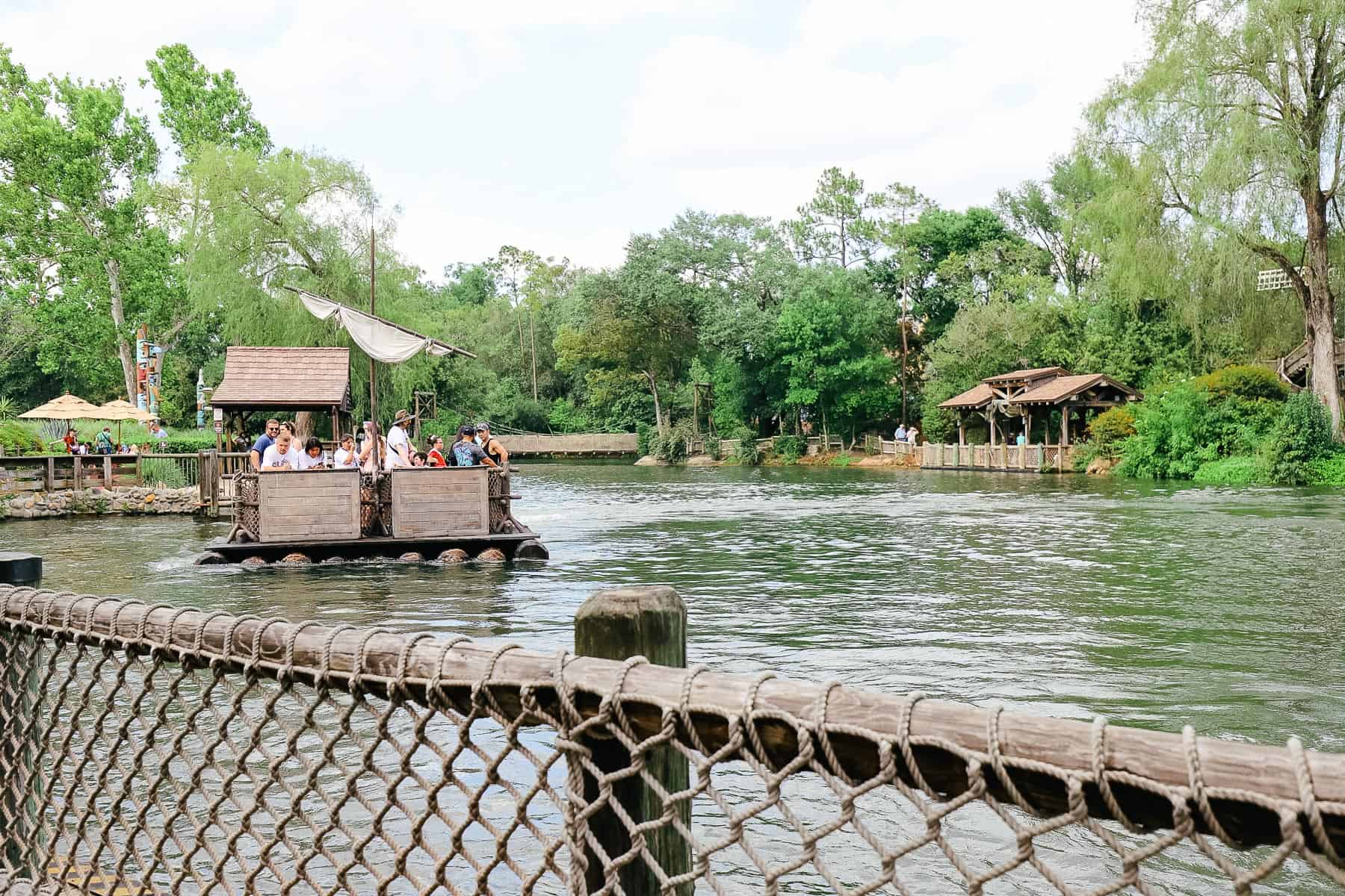 Guests riding a raft to Tom Sawyer Island. 